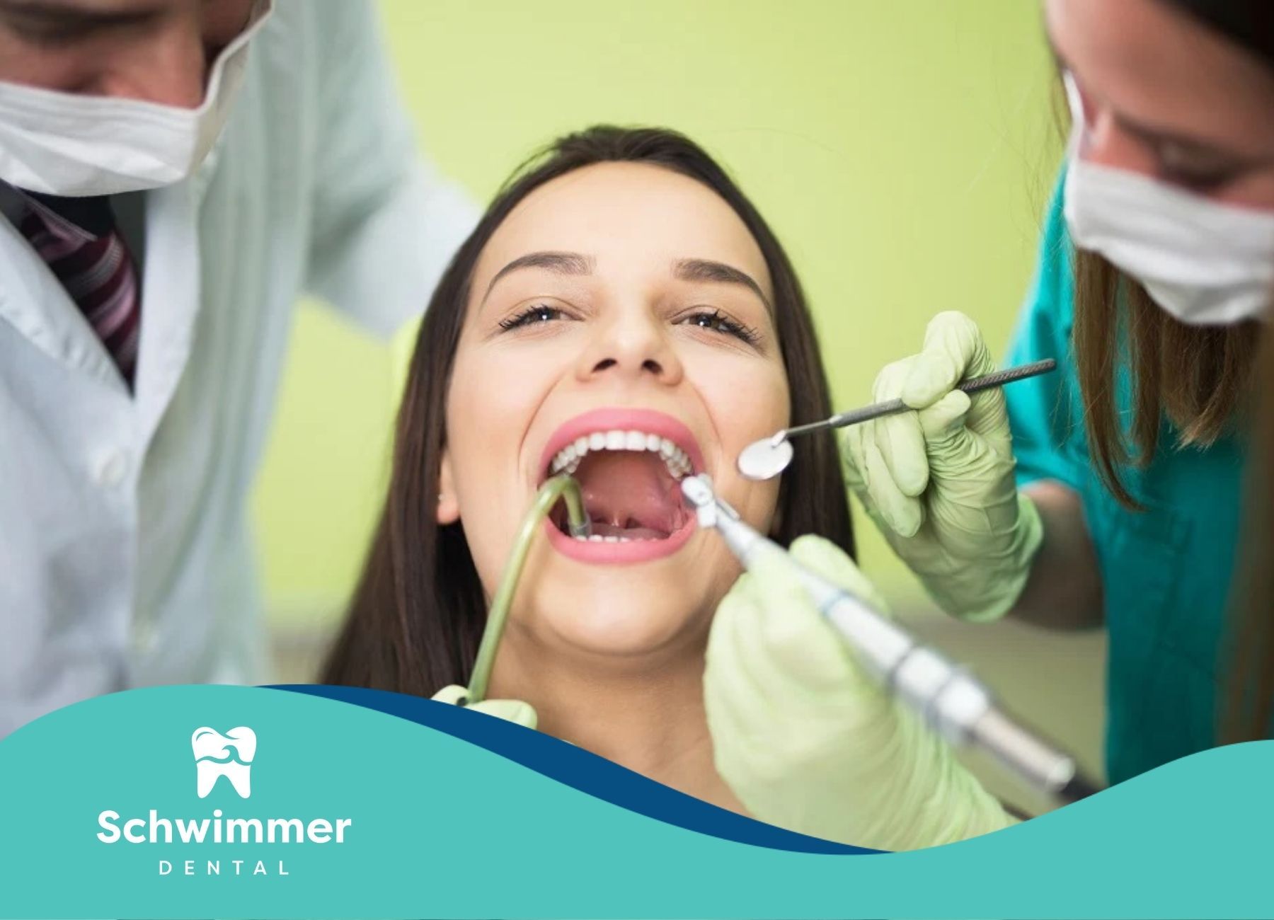 A woman receiving dental treatment from two dentists using tools in her mouth at a clinic in NJ.