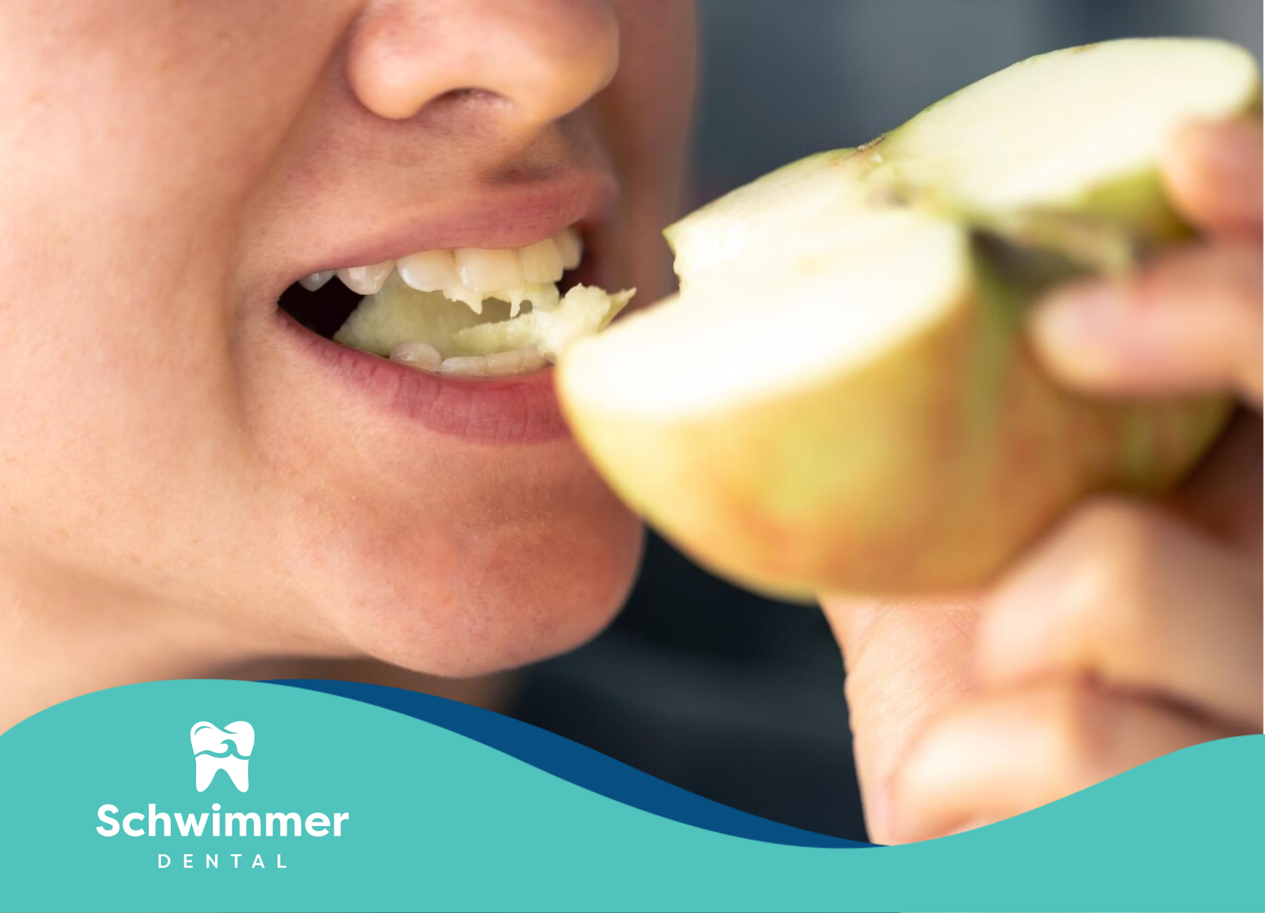 A close-up shot of a girl biting an apple