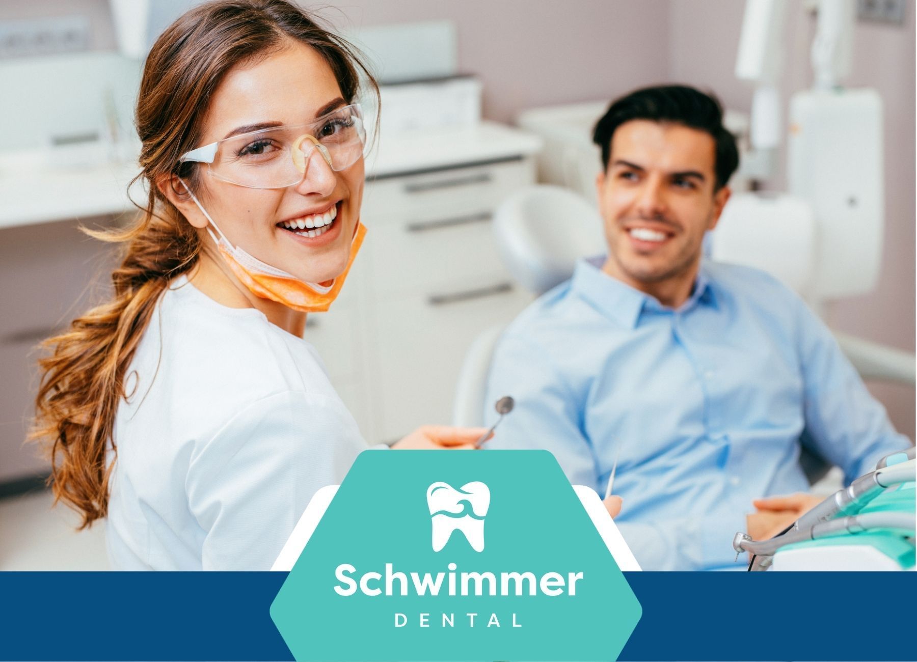 A woman is standing next to a man in a dental chair.