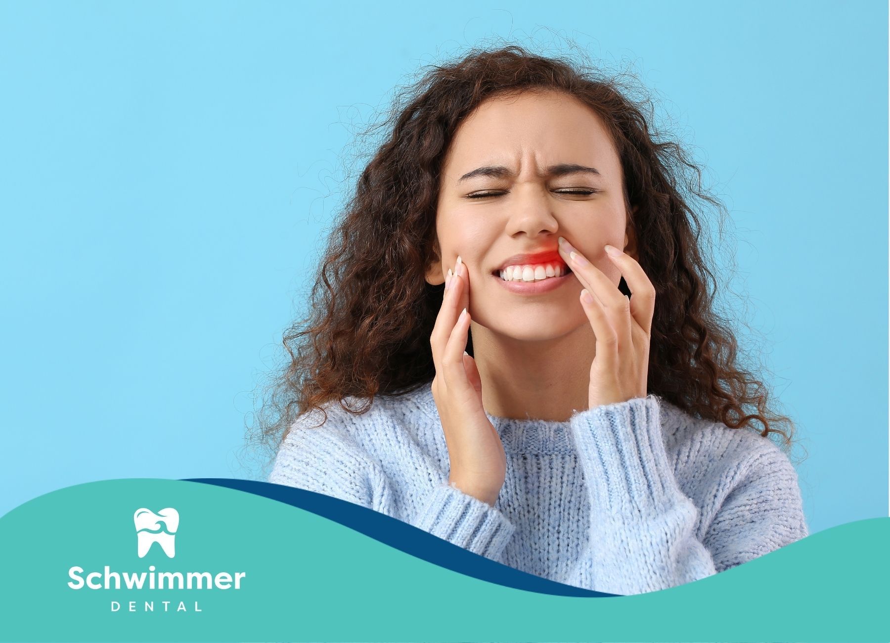 A woman is holding her face in pain because of a gum disease.