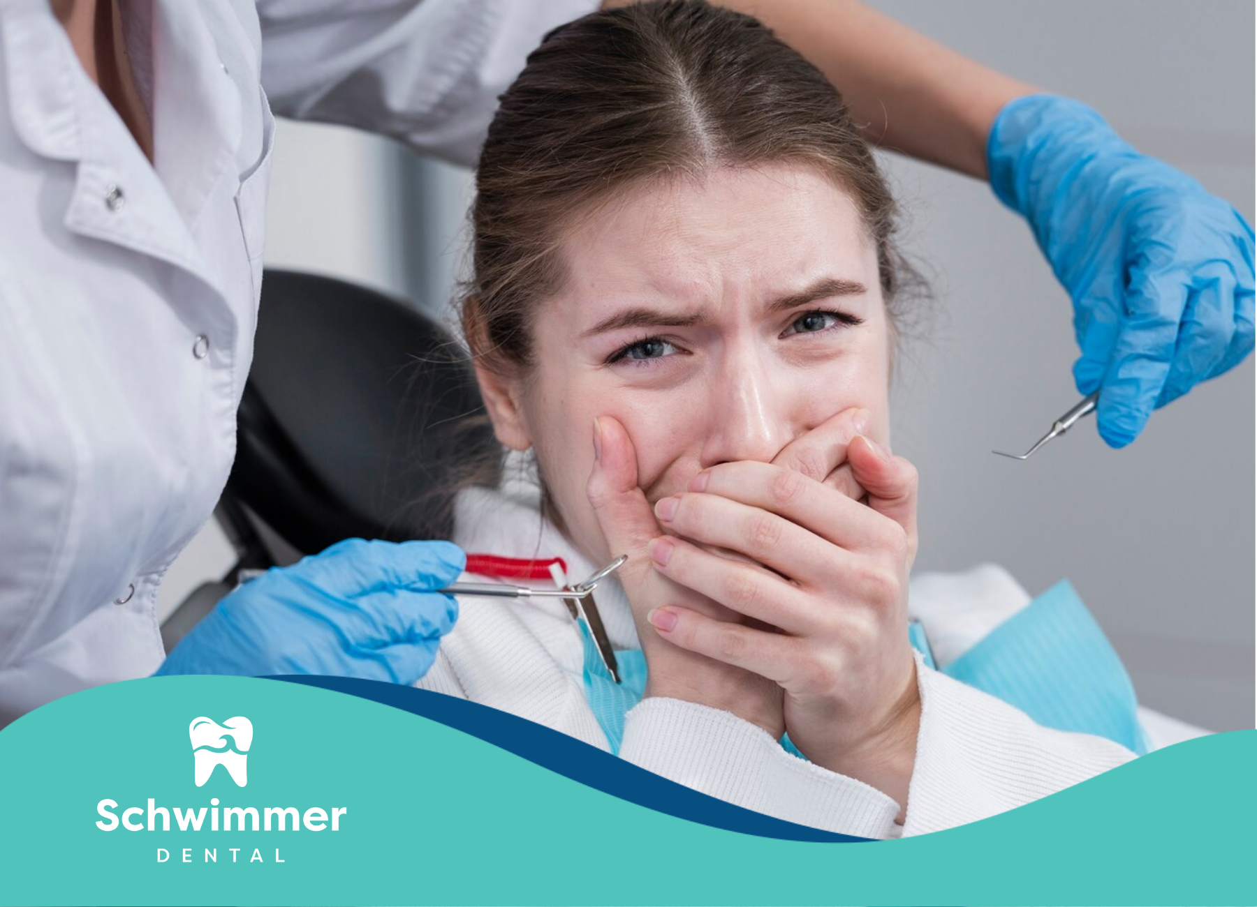 A woman is covering her mouth while sitting in a dental chair