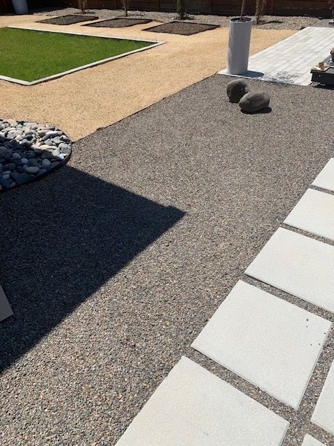 A concrete walkway with a grassy area in the background