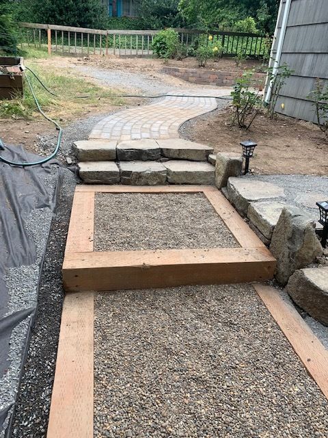 A stone walkway with stairs leading up to a house.