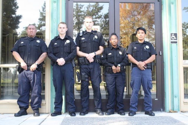 A group of police officers standing in front of a building