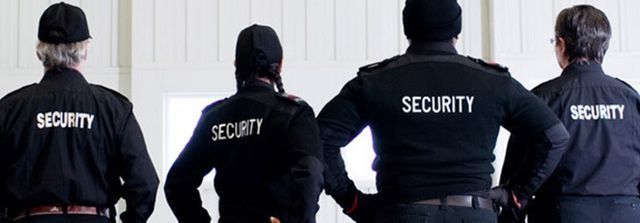 A group of security guards are standing next to each other.