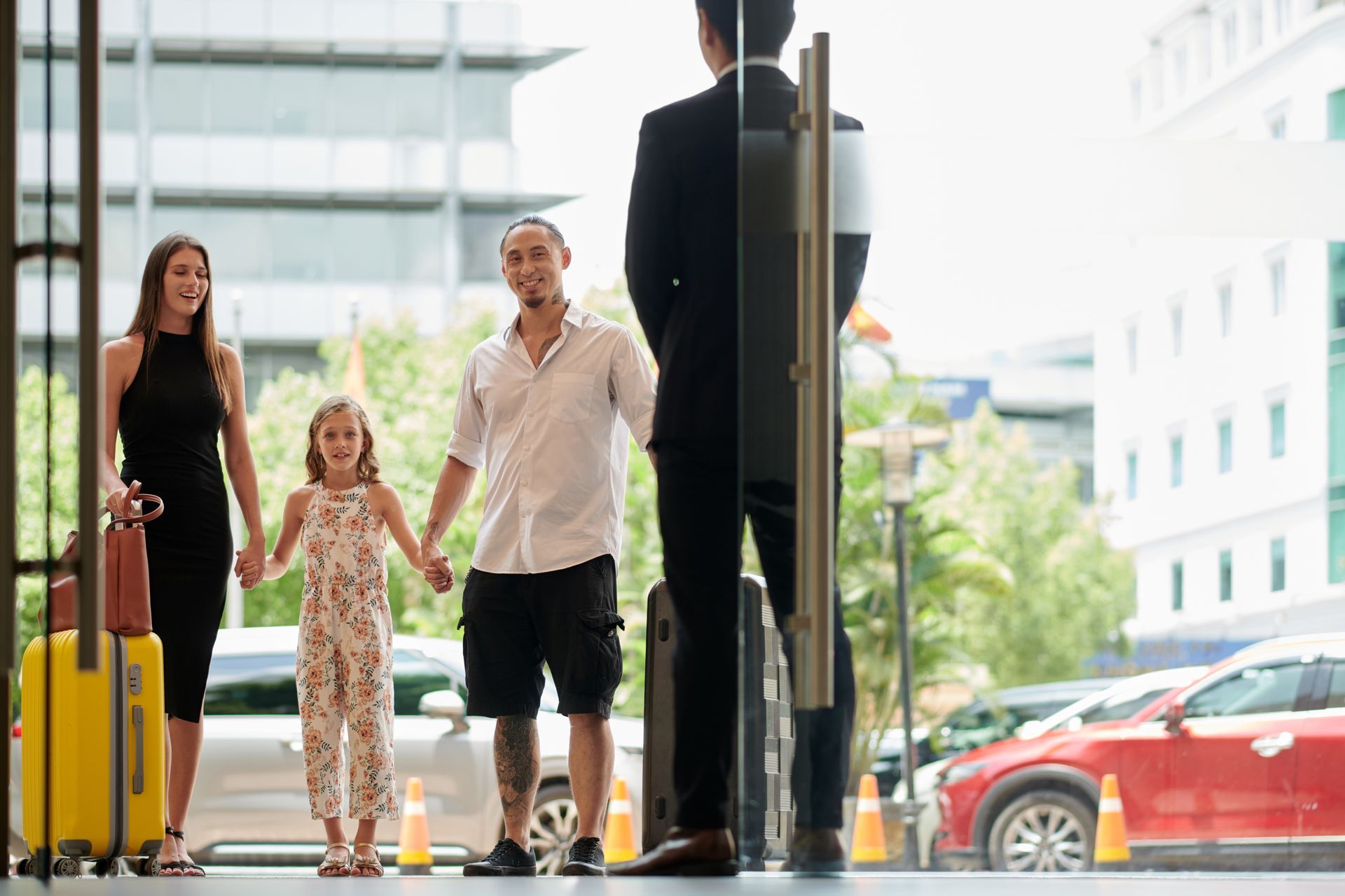 Family talking to concierge in the entrance hall of a hotel.