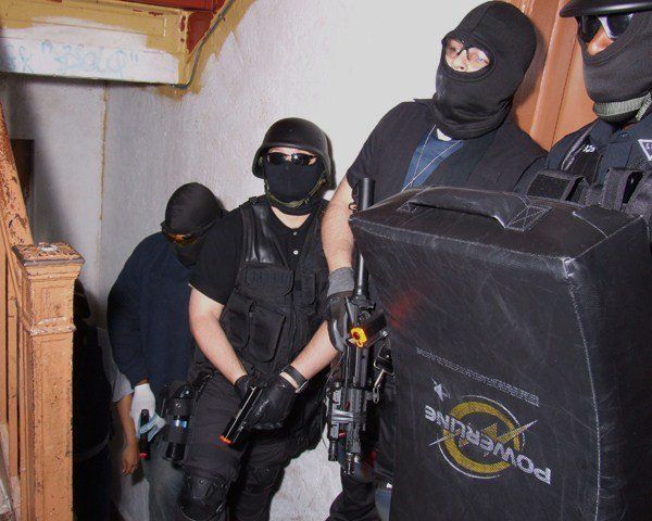 A group of soldiers are standing next to a powerline shield