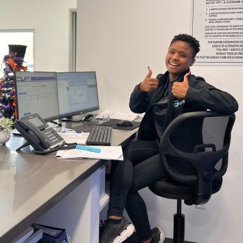 Person with Short Hair Sits at a Desk | Crown City Tire Auto Care