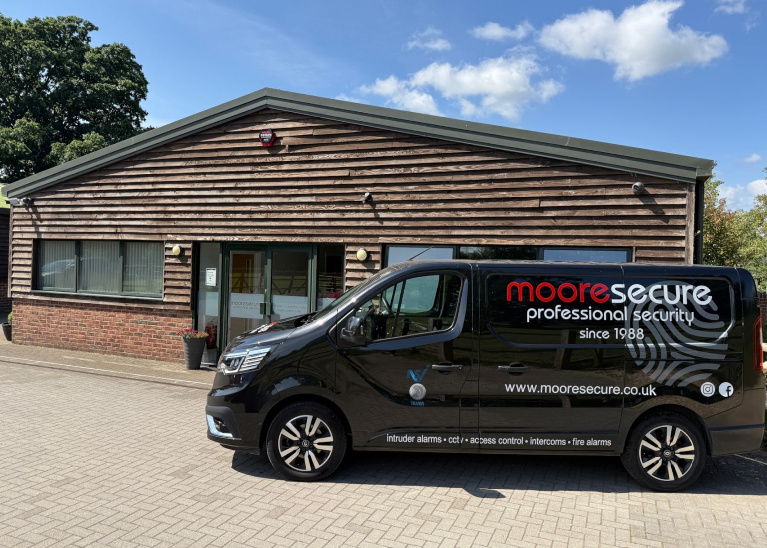 Moore Secure Offices showing sign written van