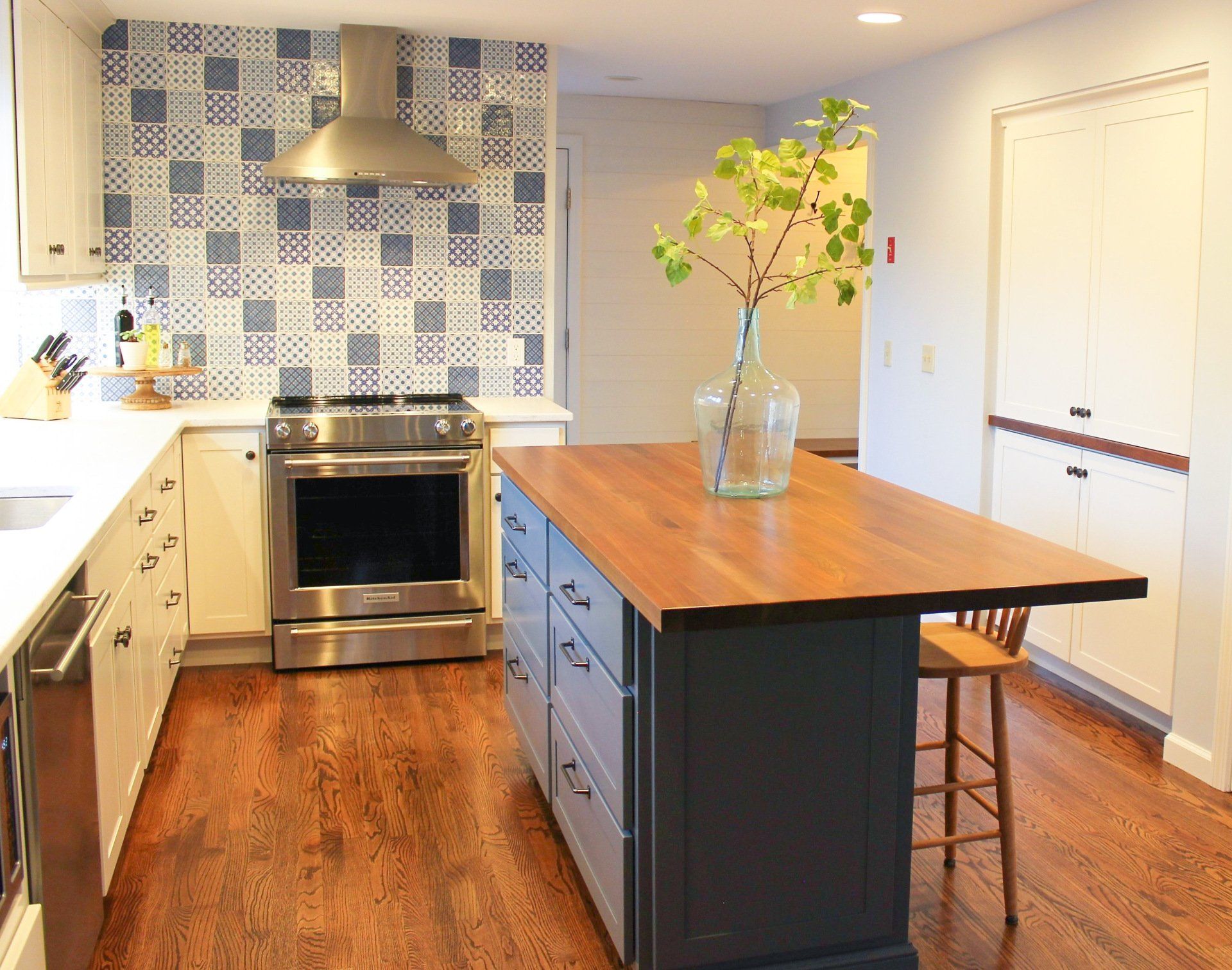 a kitchen with stainless steel appliances and white cabinets