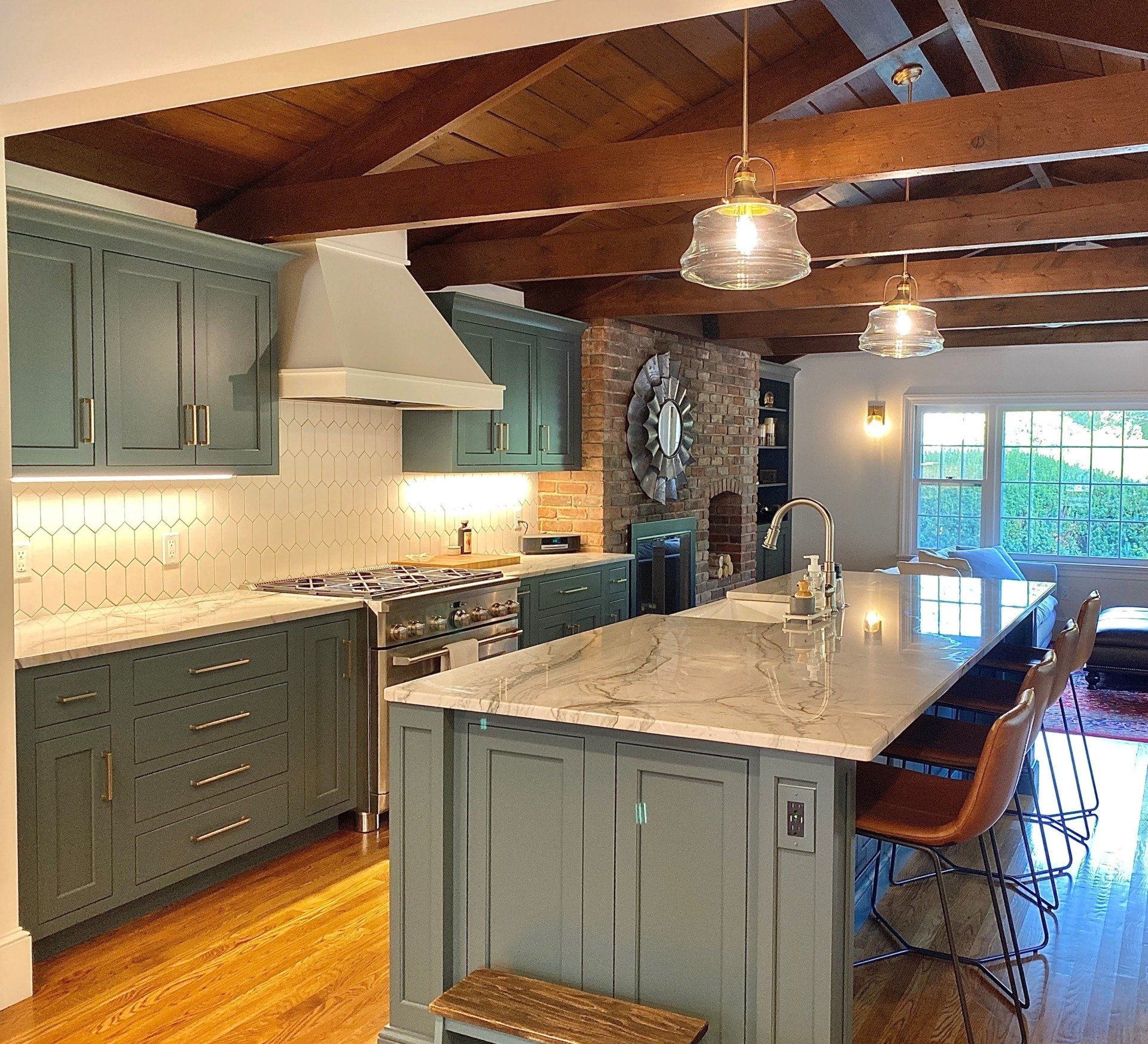a kitchen with green cabinets and white counter tops