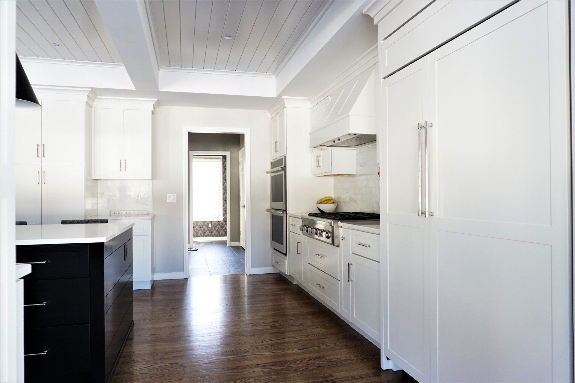 a kitchen with white cabinets and stainless steel appliances