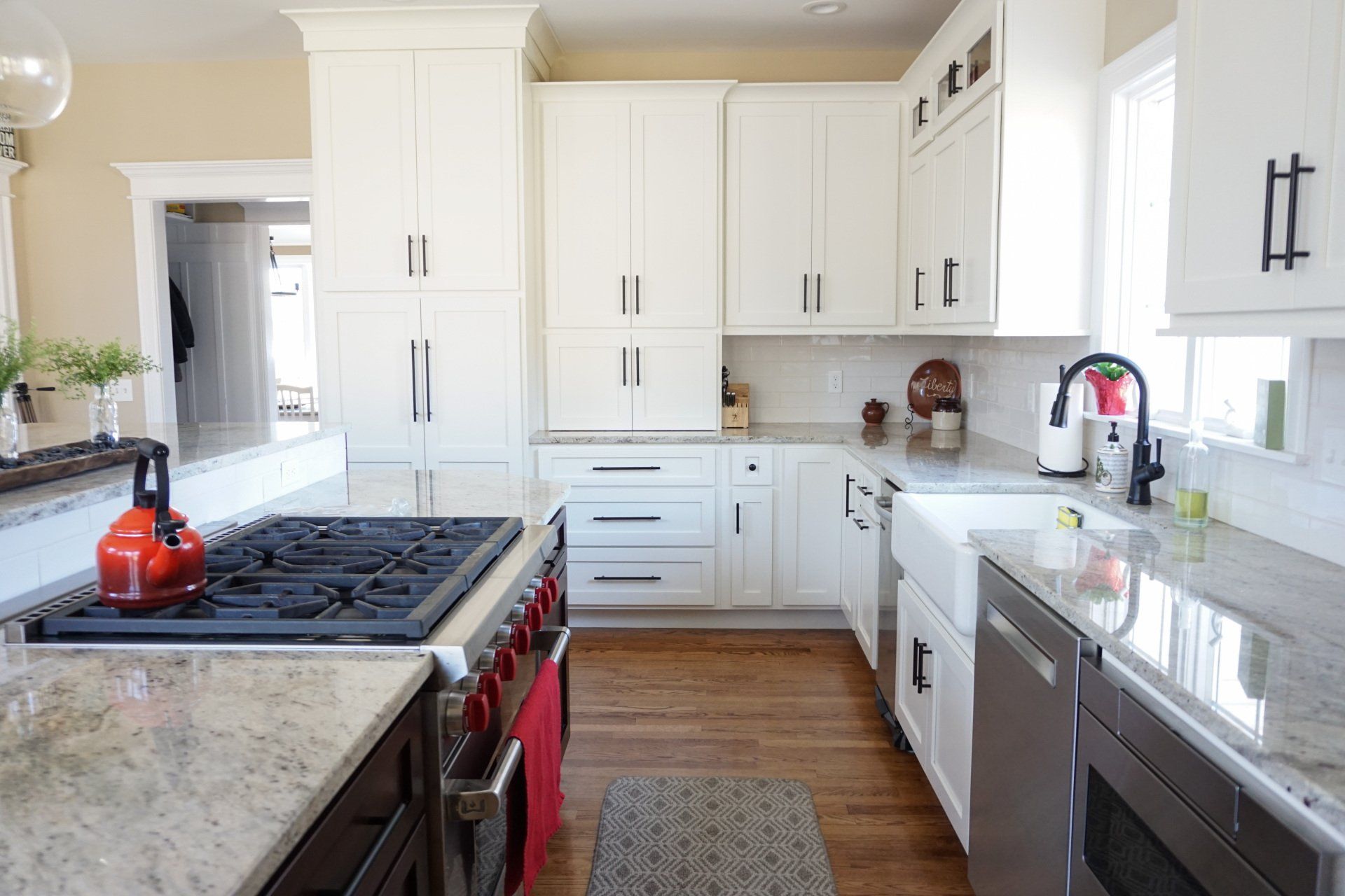 a kitchen with white cabinets and stainless steel appliances