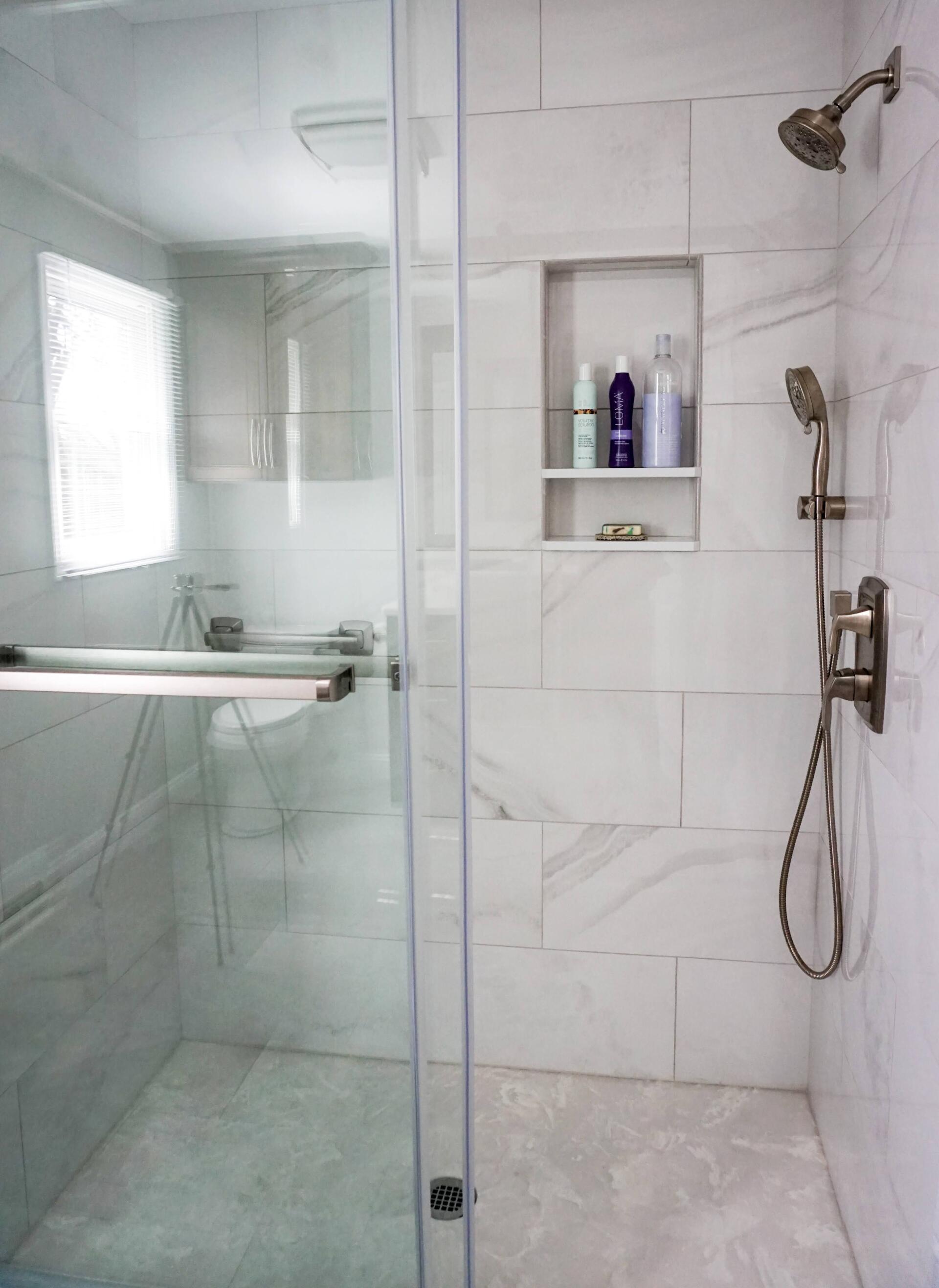 new white marble style shower tile and glass door 