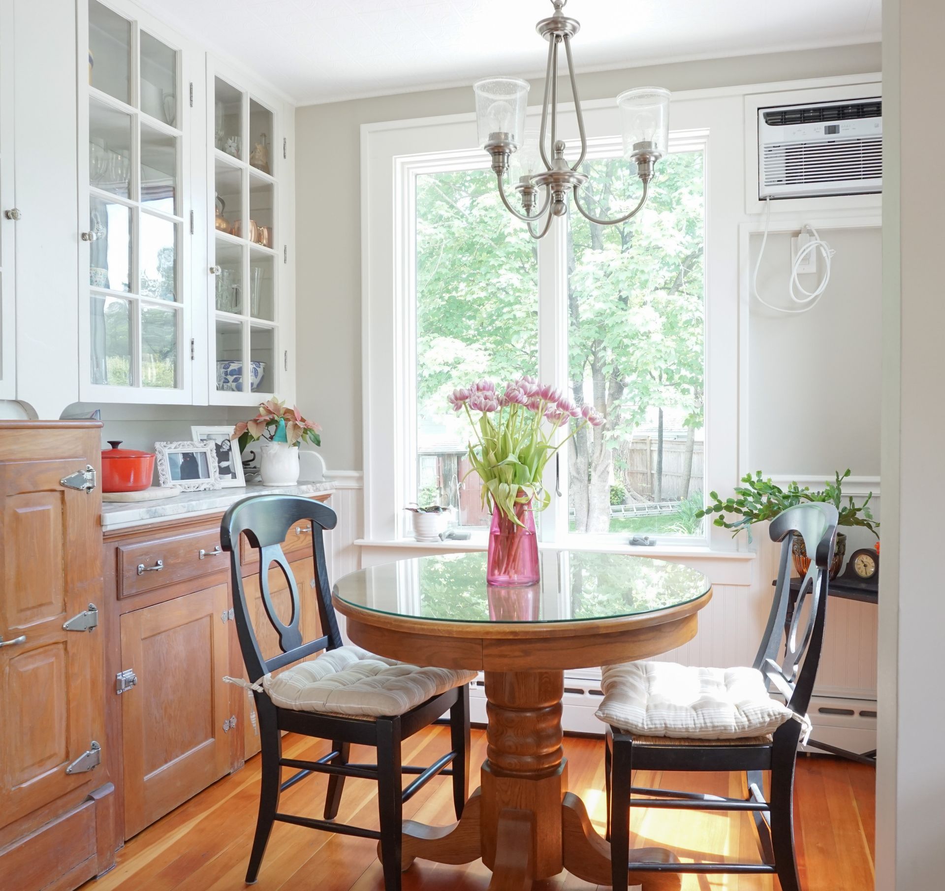 a kitchen with a table and chairs and a window