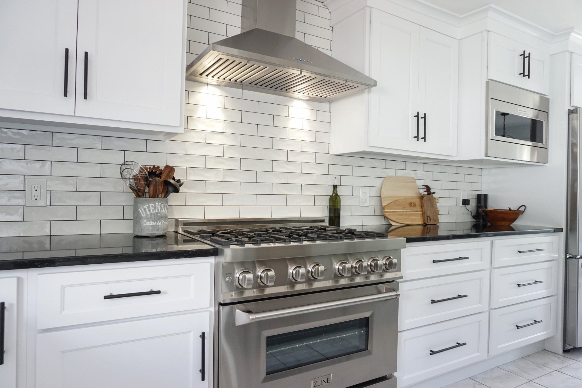 a kitchen with stainless steel appliances and white cabinets