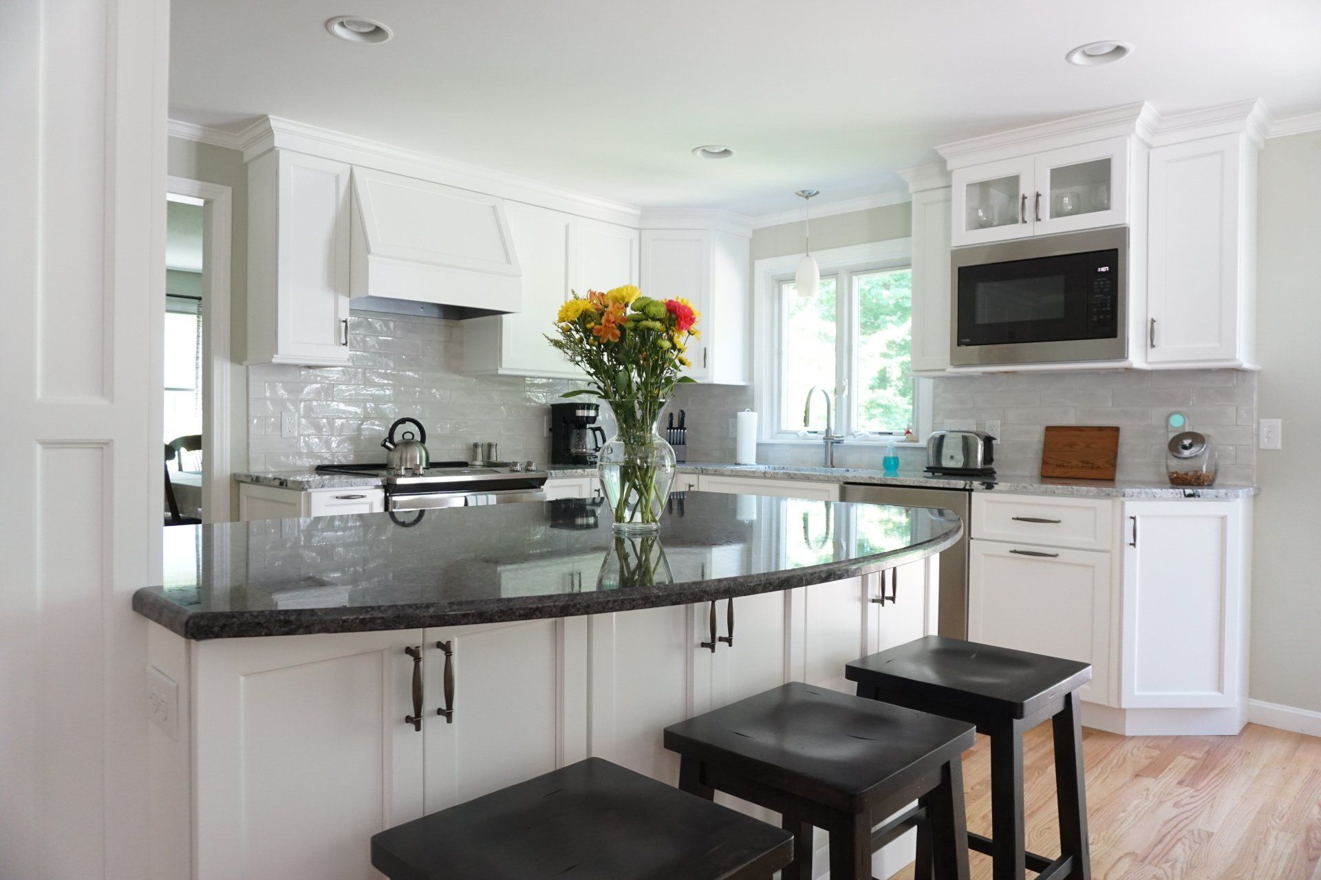 a kitchen with a vase of flowers on the counter
