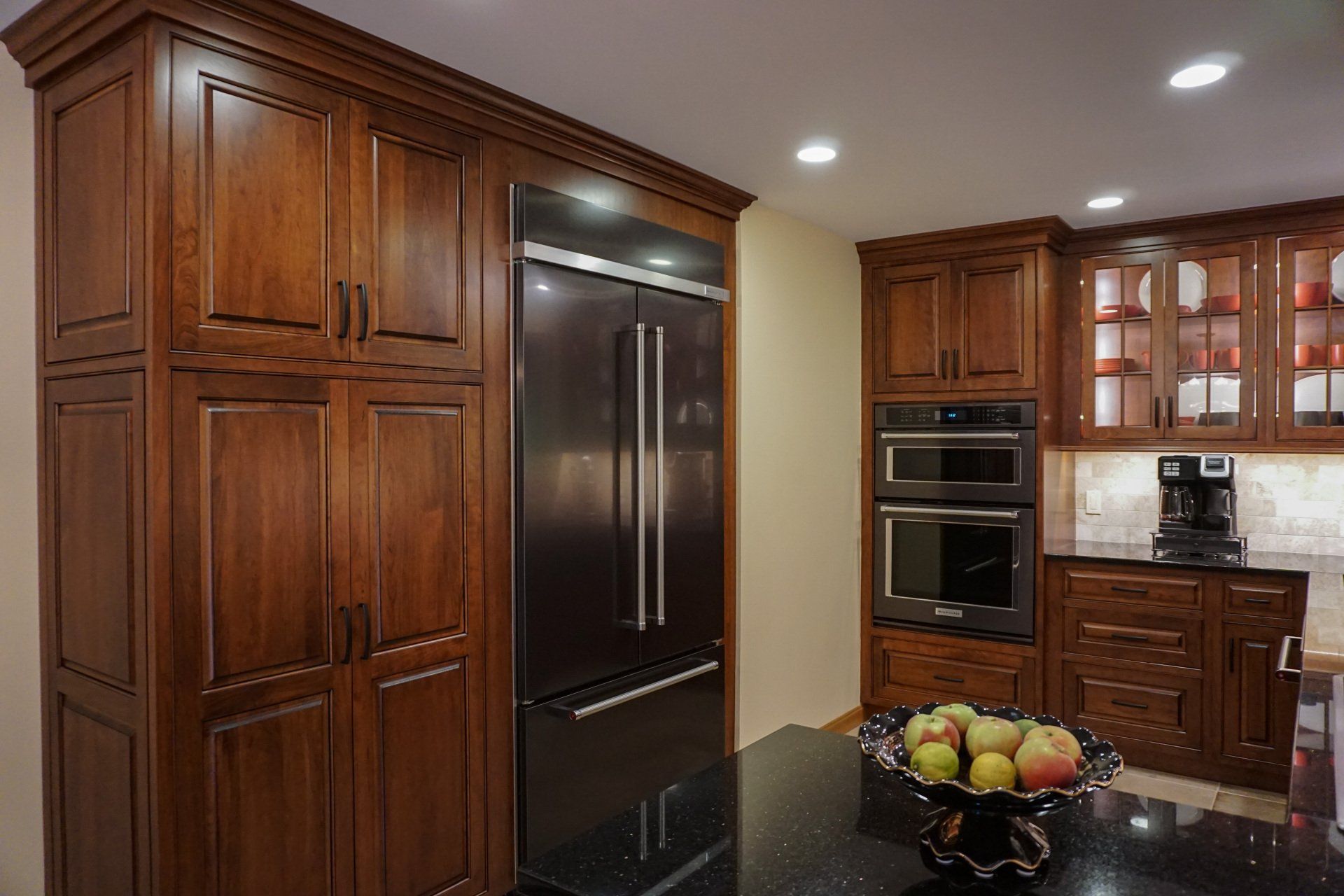 a kitchen with stainless steel appliances and wooden cabinets