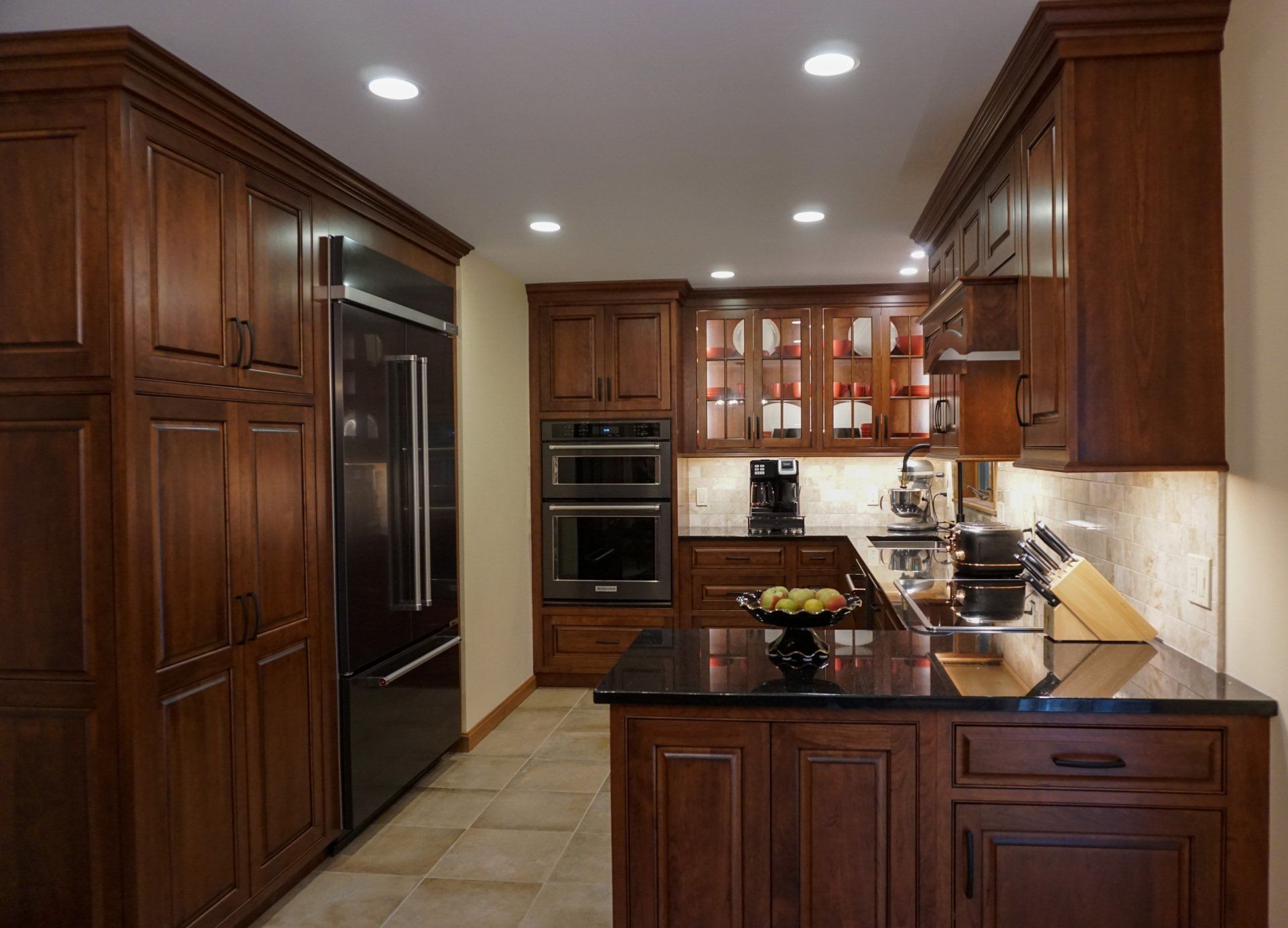 a kitchen with wooden cabinets and stainless steel appliances