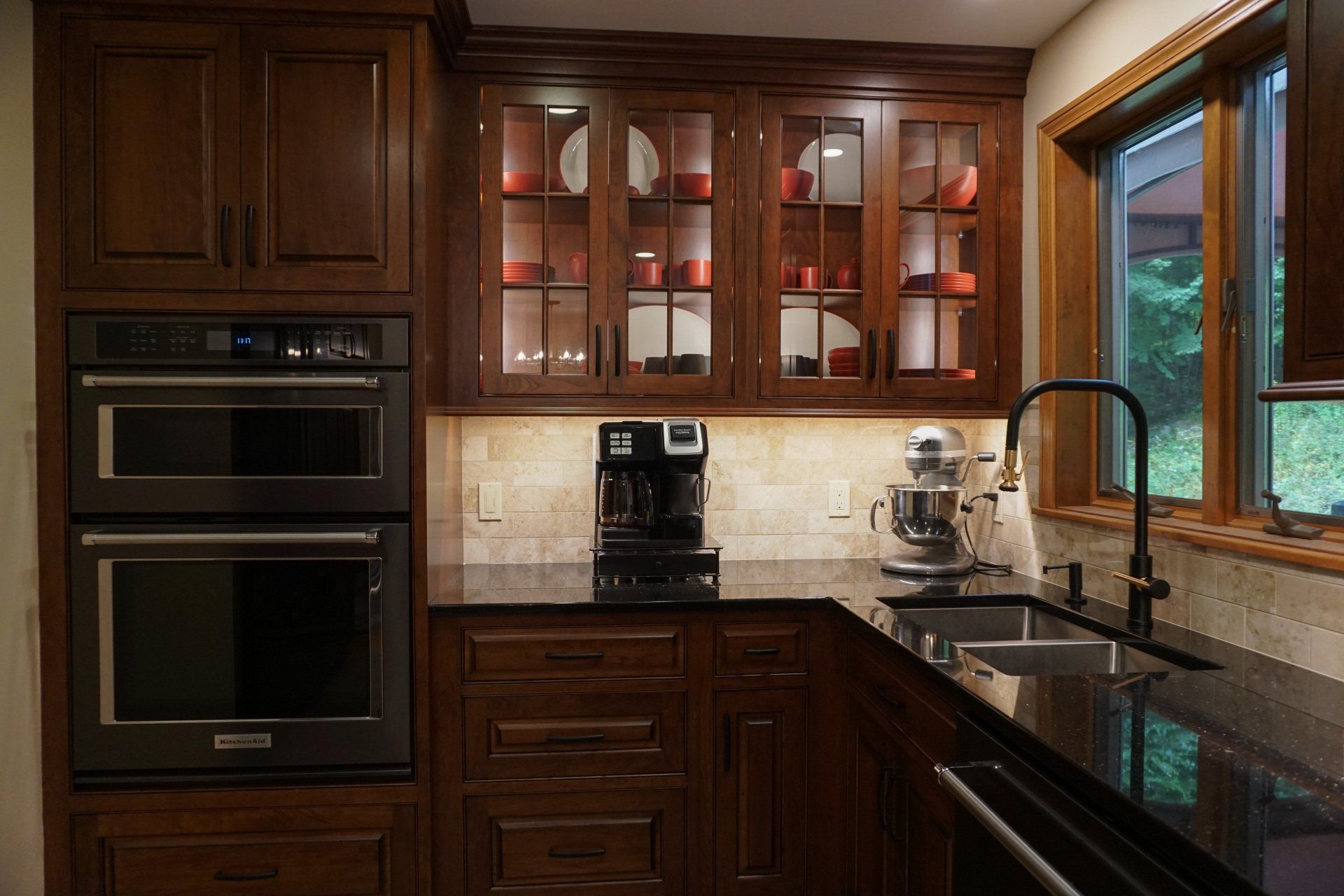 a kitchen with two ovens and a KitchenAid mixer