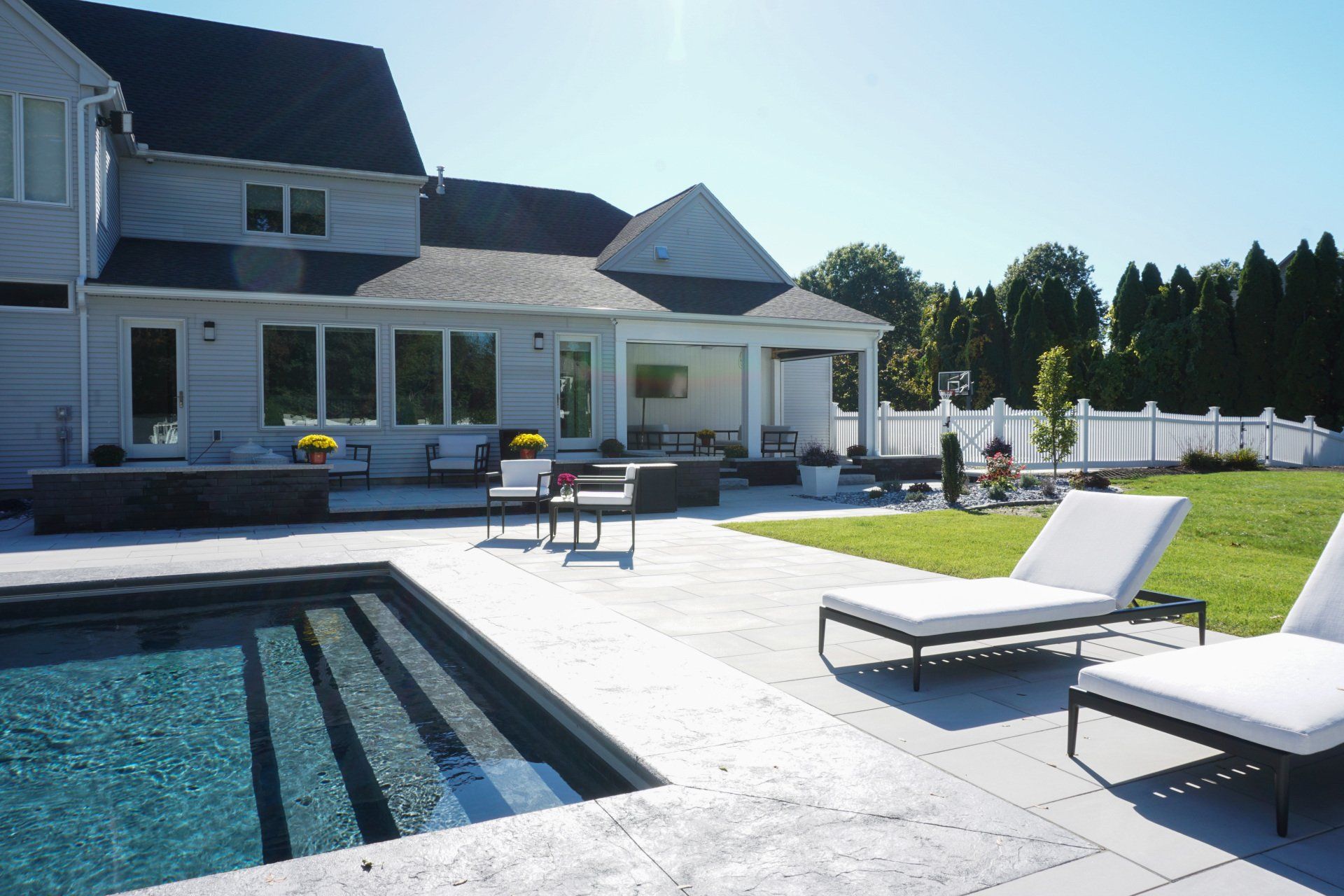 A large house with a swimming pool in front of it