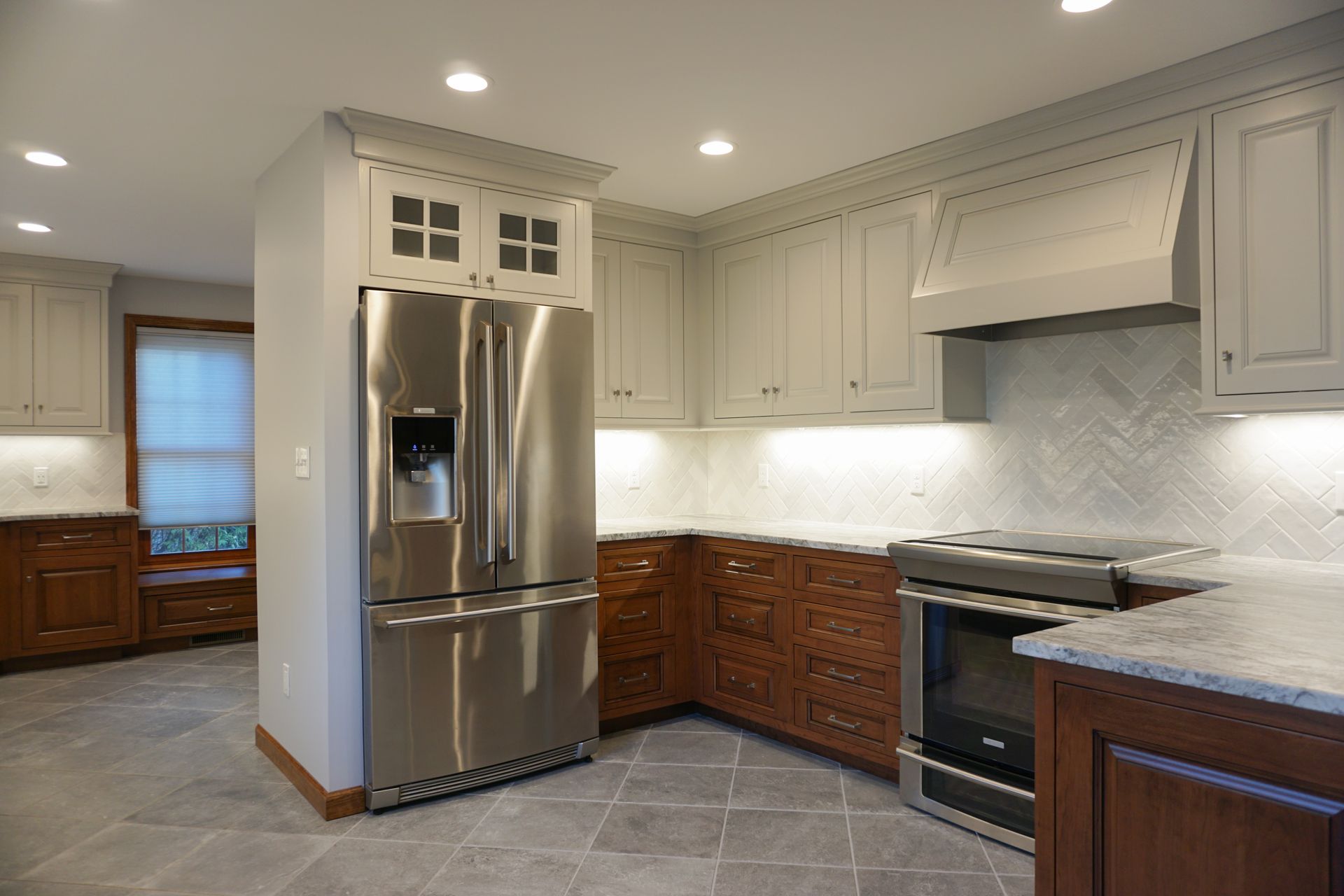 a kitchen with a stainless steel refrigerator and a stove
