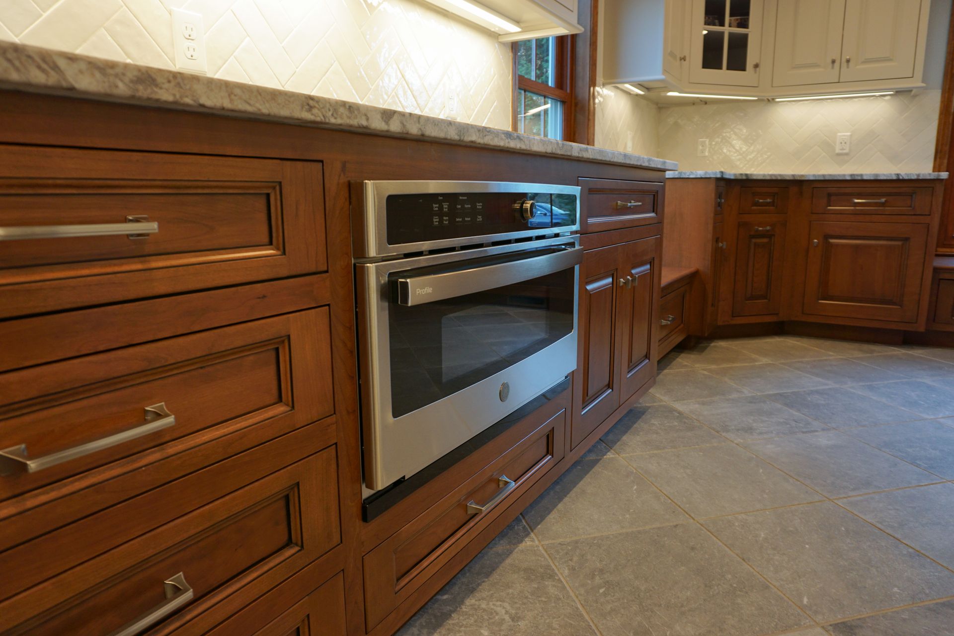 a kitchen with wooden cabinets and a stainless steel oven