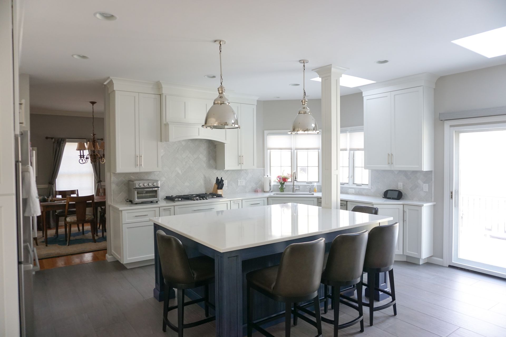a kitchen with white cabinets and a large island