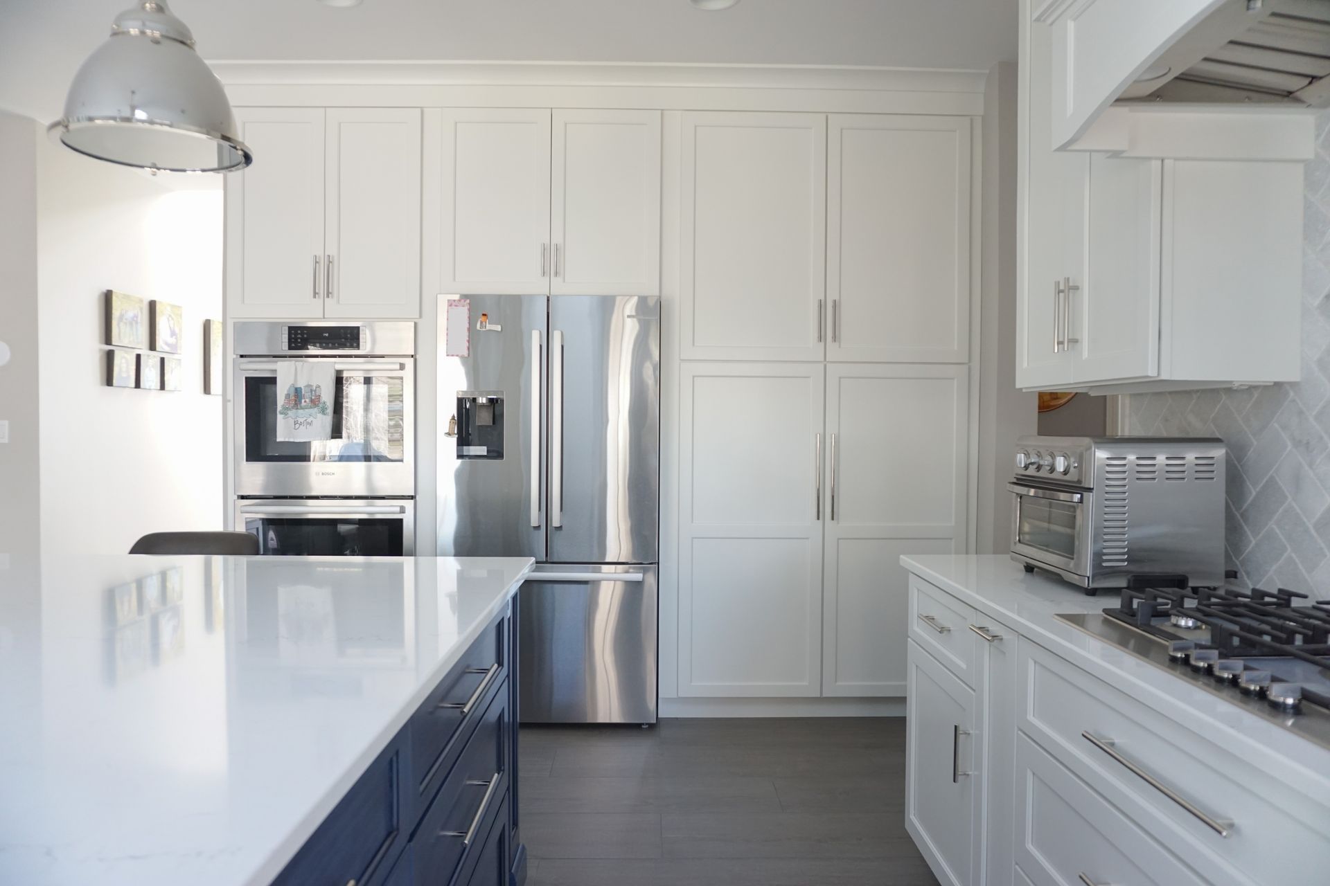 a kitchen with stainless steel appliances and white cabinets