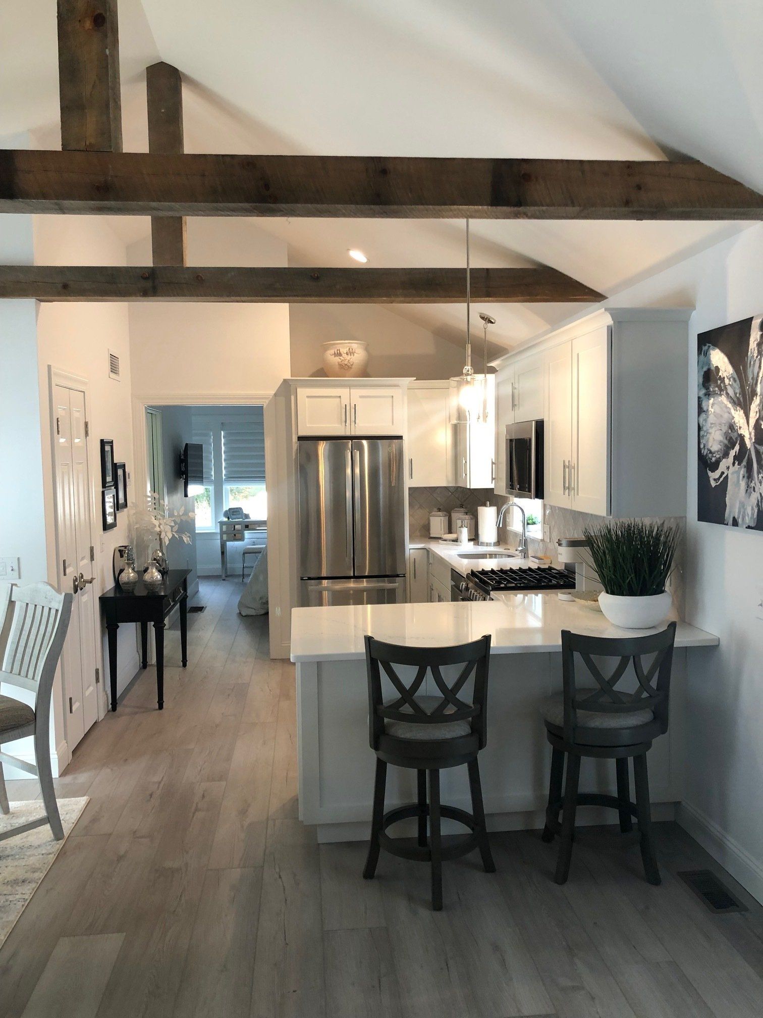 A kitchen with white cabinets and stainless steel appliances