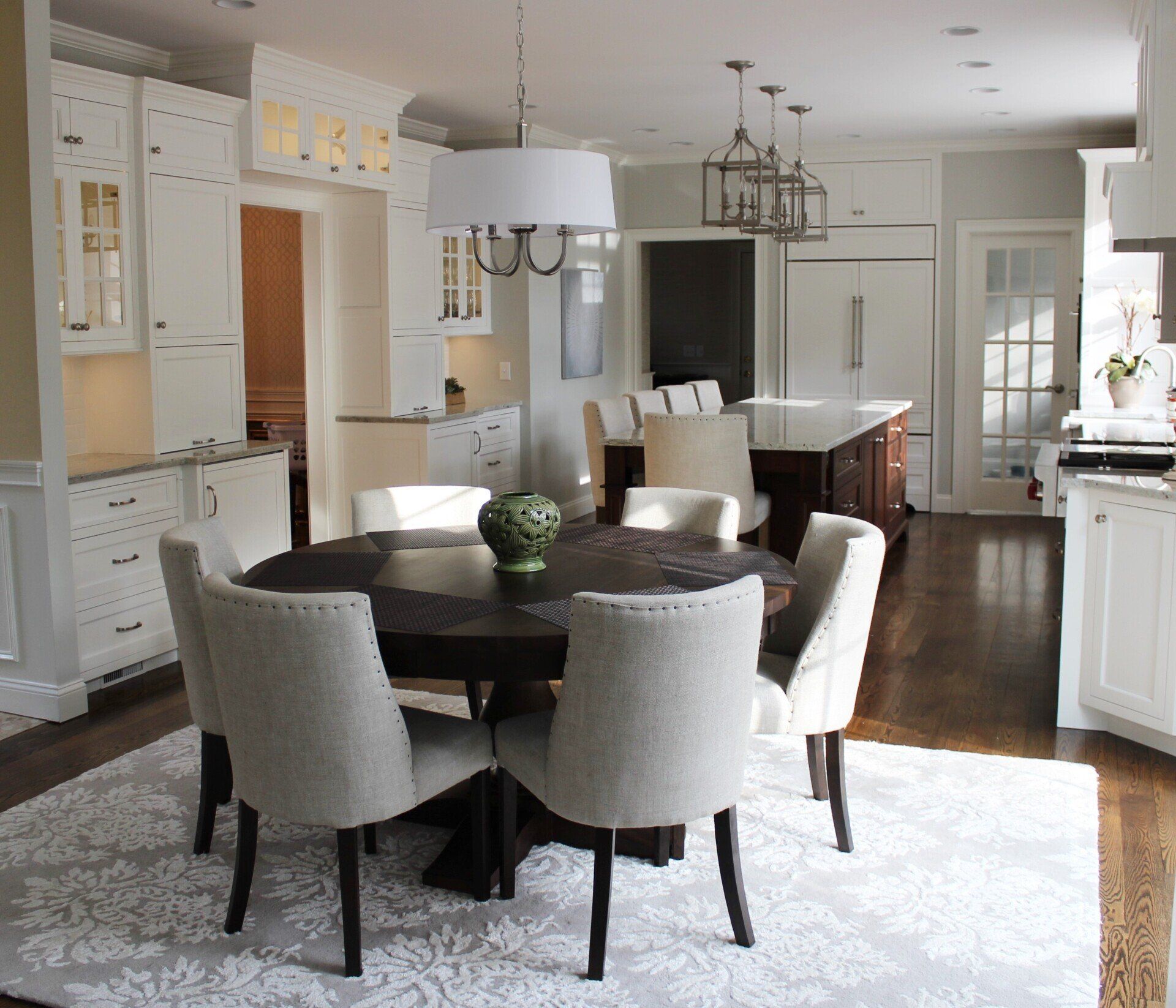 a dining room with a round table and chairs