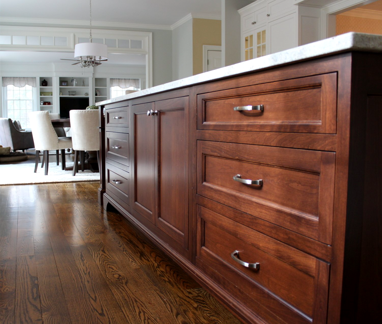 a kitchen with wooden cabinets and marble counter tops