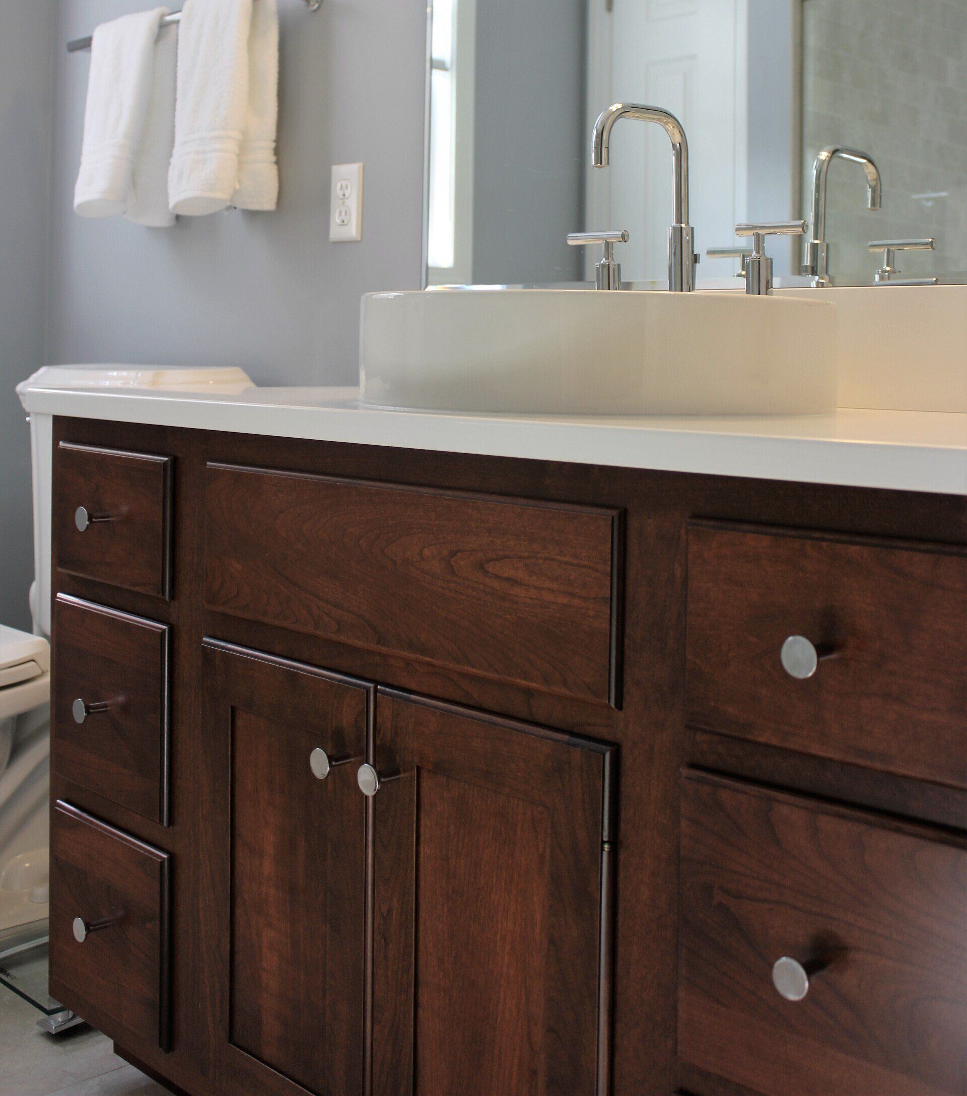 dark stained wood with modern white countertop and sink bathroom renovation in Ludlow, MA