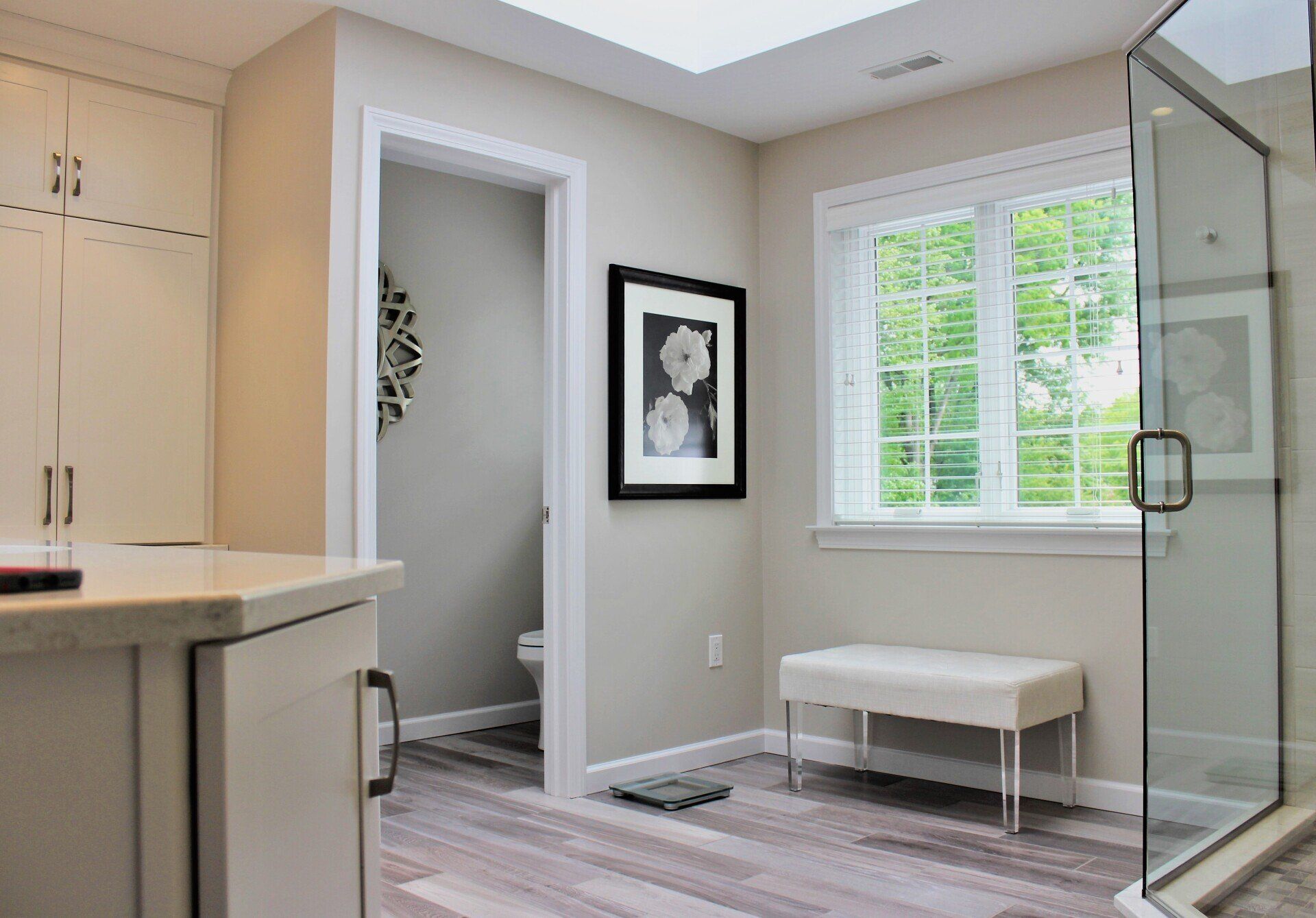 a bathroom with a walk in shower and a bench