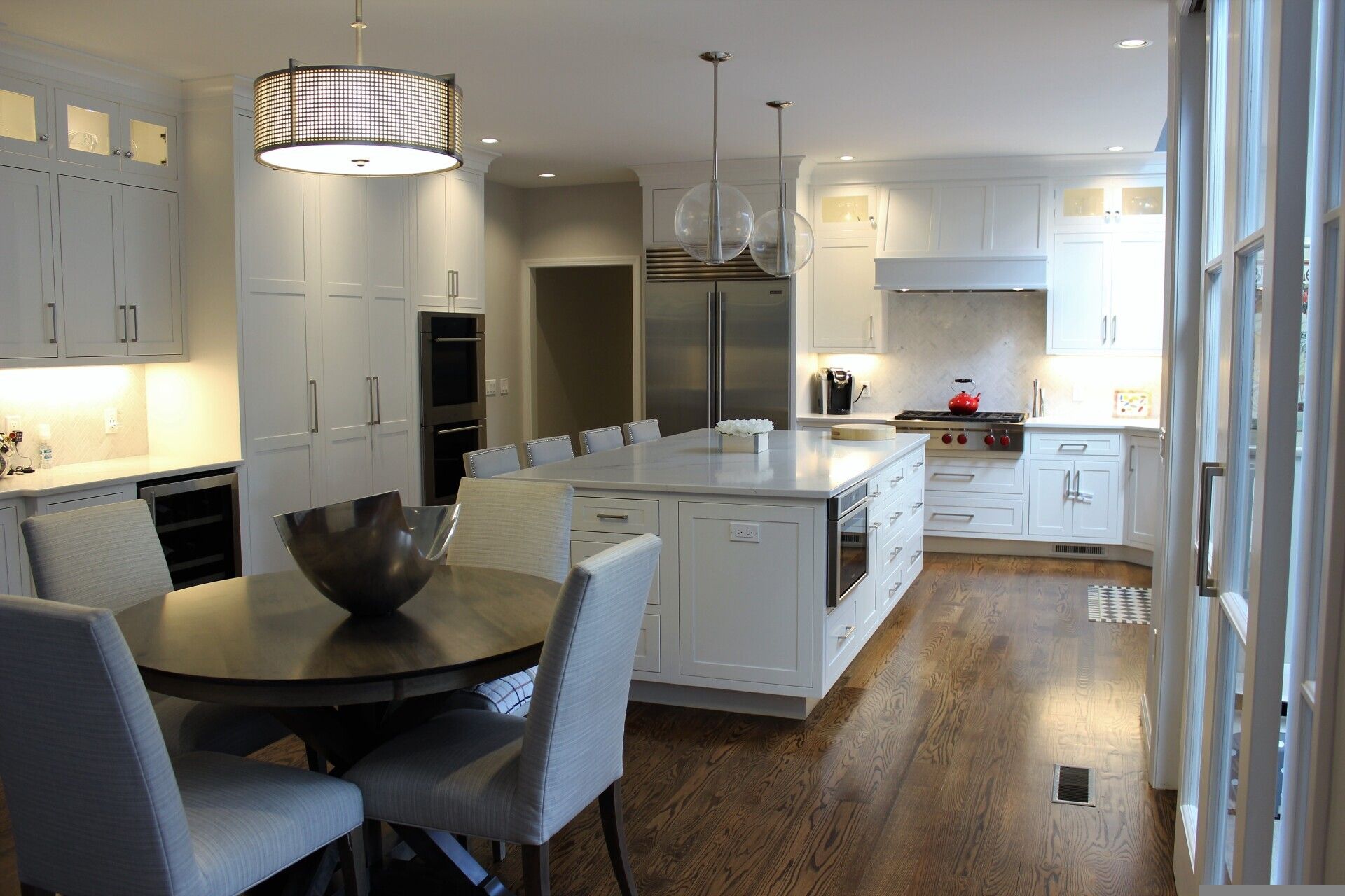 a kitchen with white cabinets and stainless steel appliances
