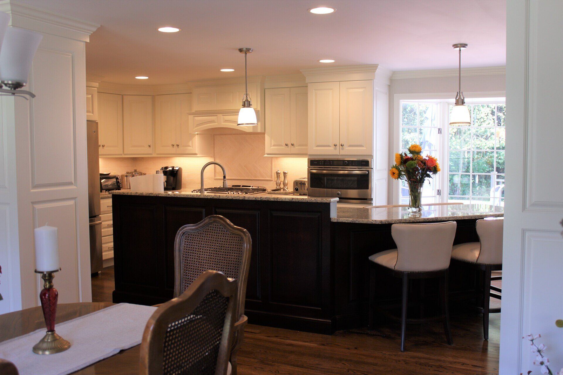 a kitchen with white cabinets and stainless steel appliances