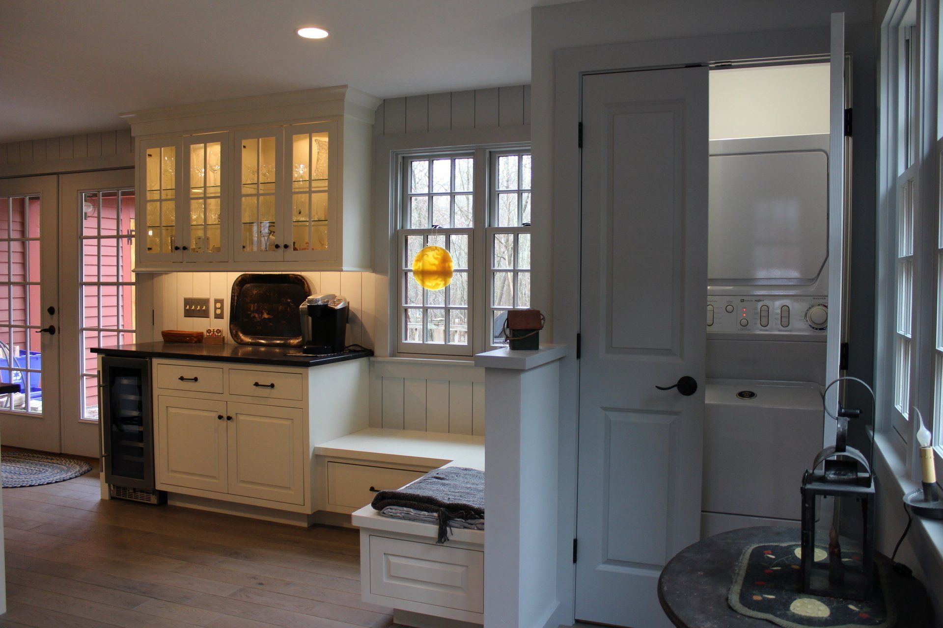 a kitchen with white cabinets and a washer and dryer