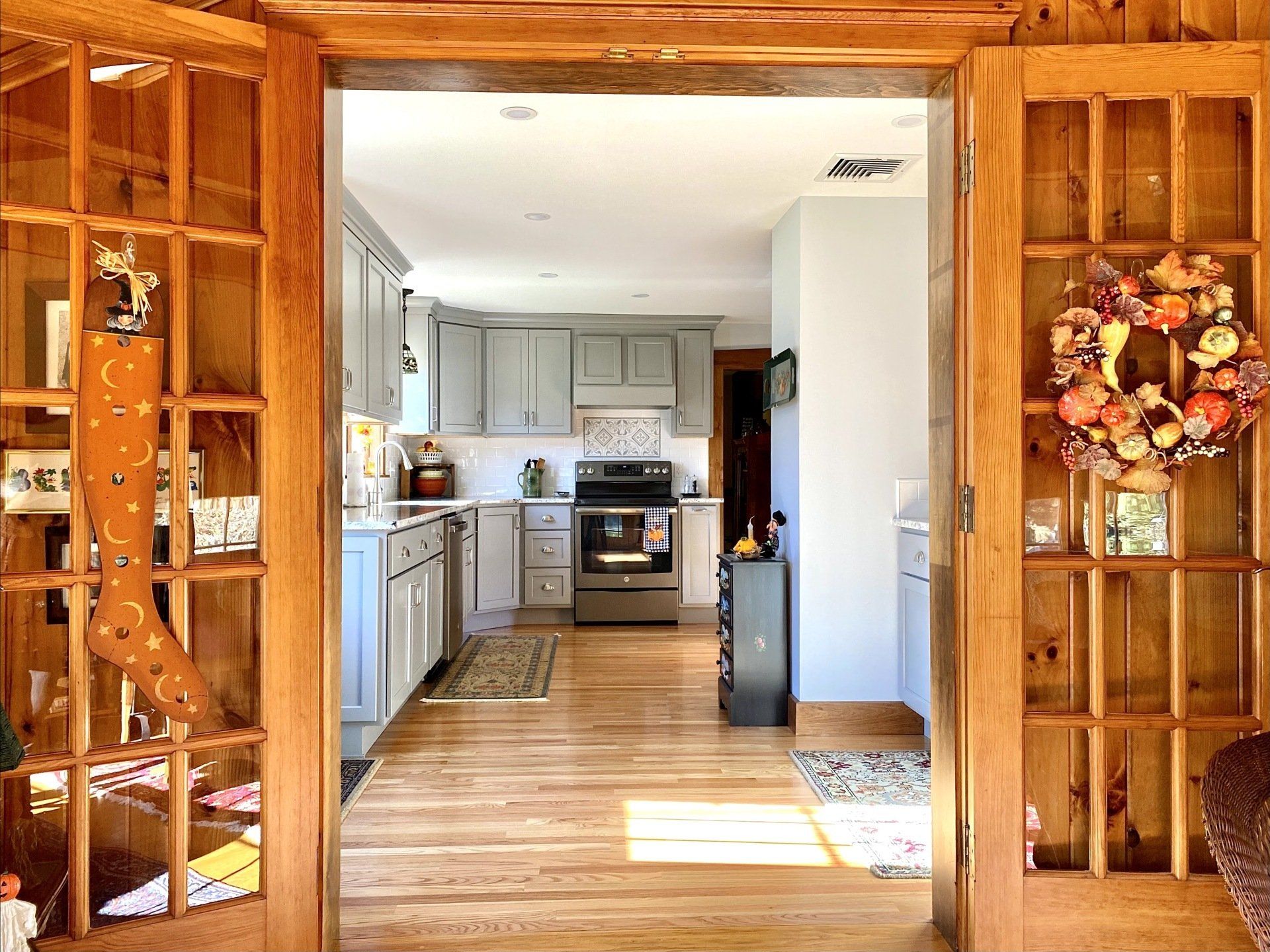 a kitchen with a wreath hanging on the wall