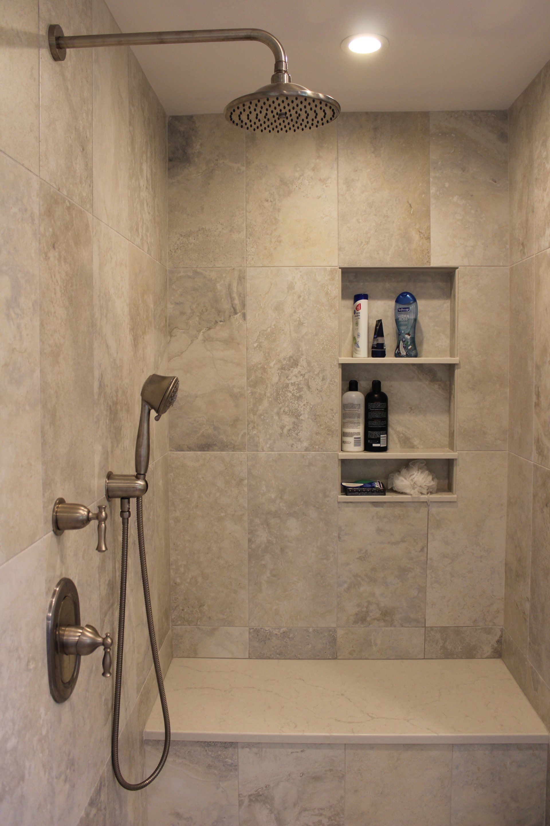 new shower remodel with 3 tier shelf, soft silver shower head and natural light brown tile