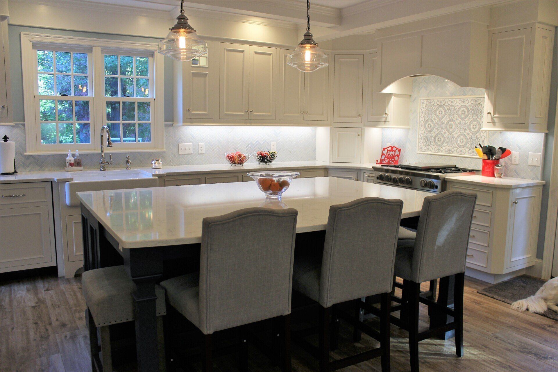 a kitchen with white cabinets and a large island