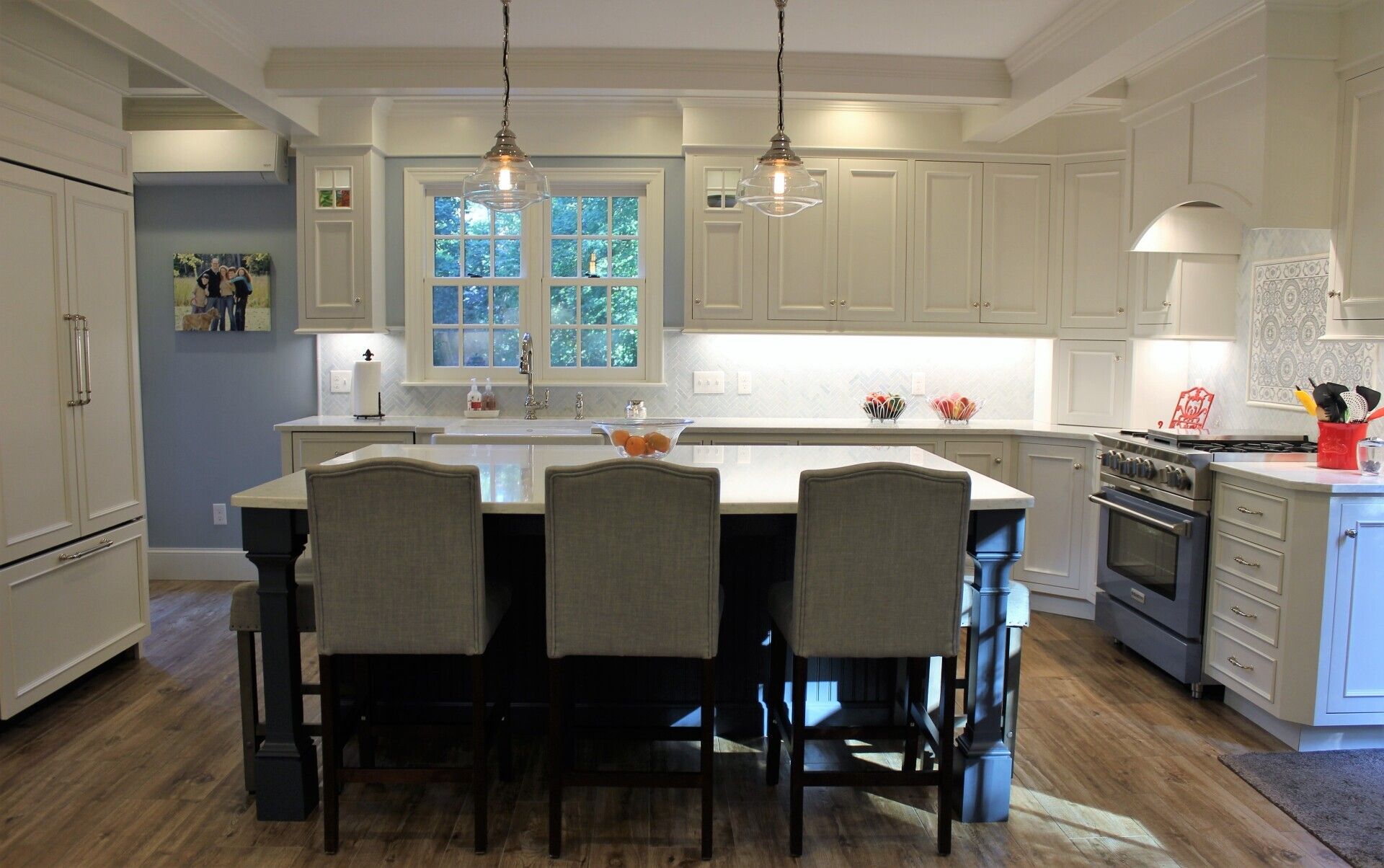 a kitchen with white cabinets and a large island