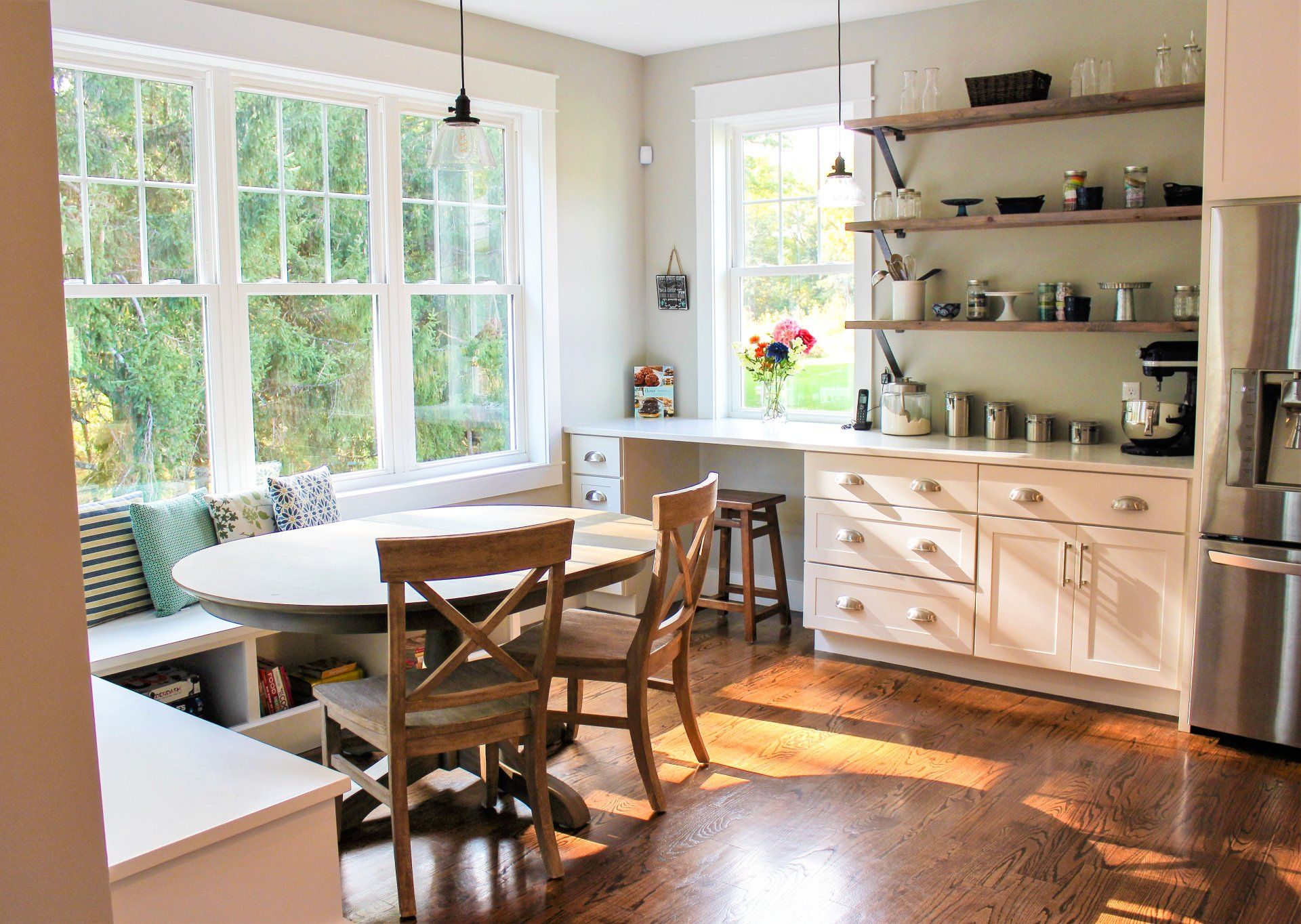 a kitchen with a table and chairs in front of a window