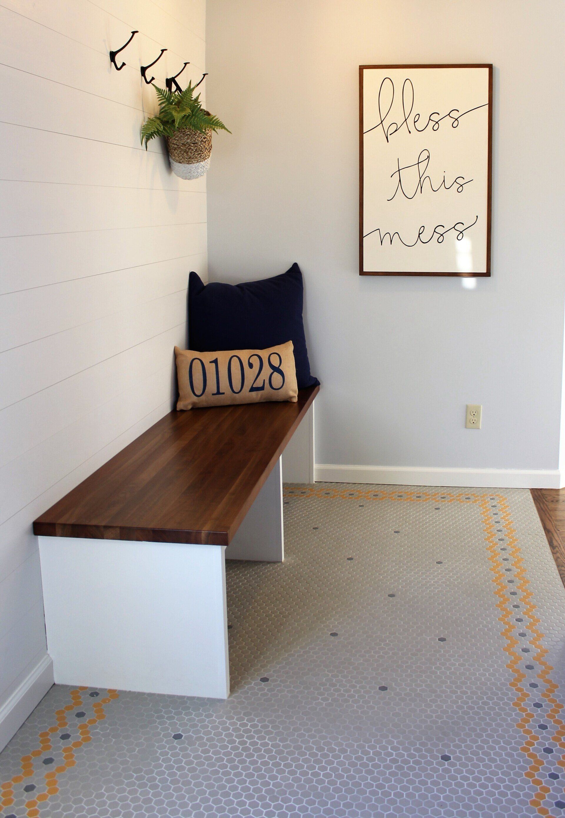 A wooden bench with a pillow that says ' 0129 ' on it