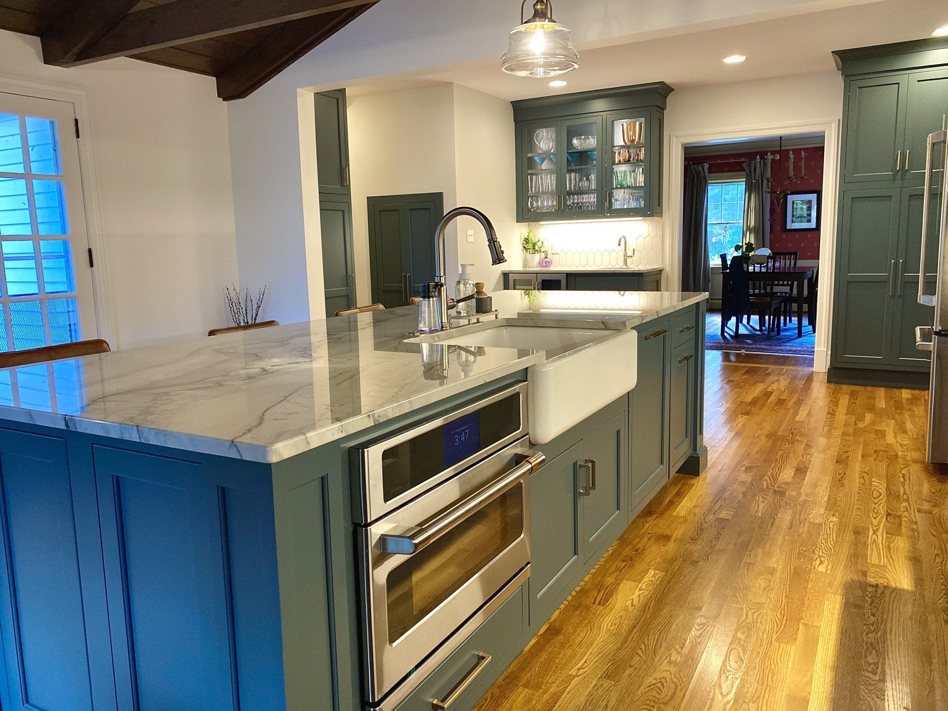 a kitchen with blue cabinets and white counter tops