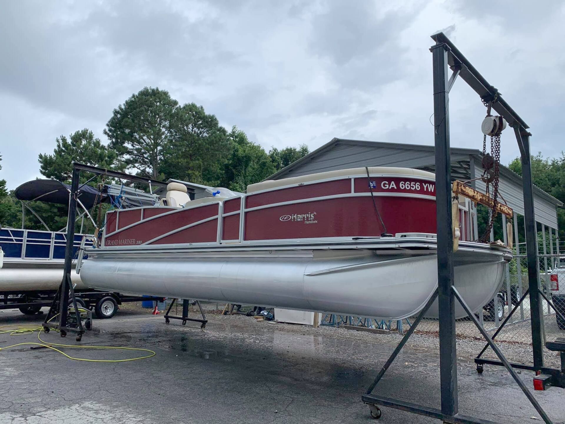 A red and white boat is parked in a garage
