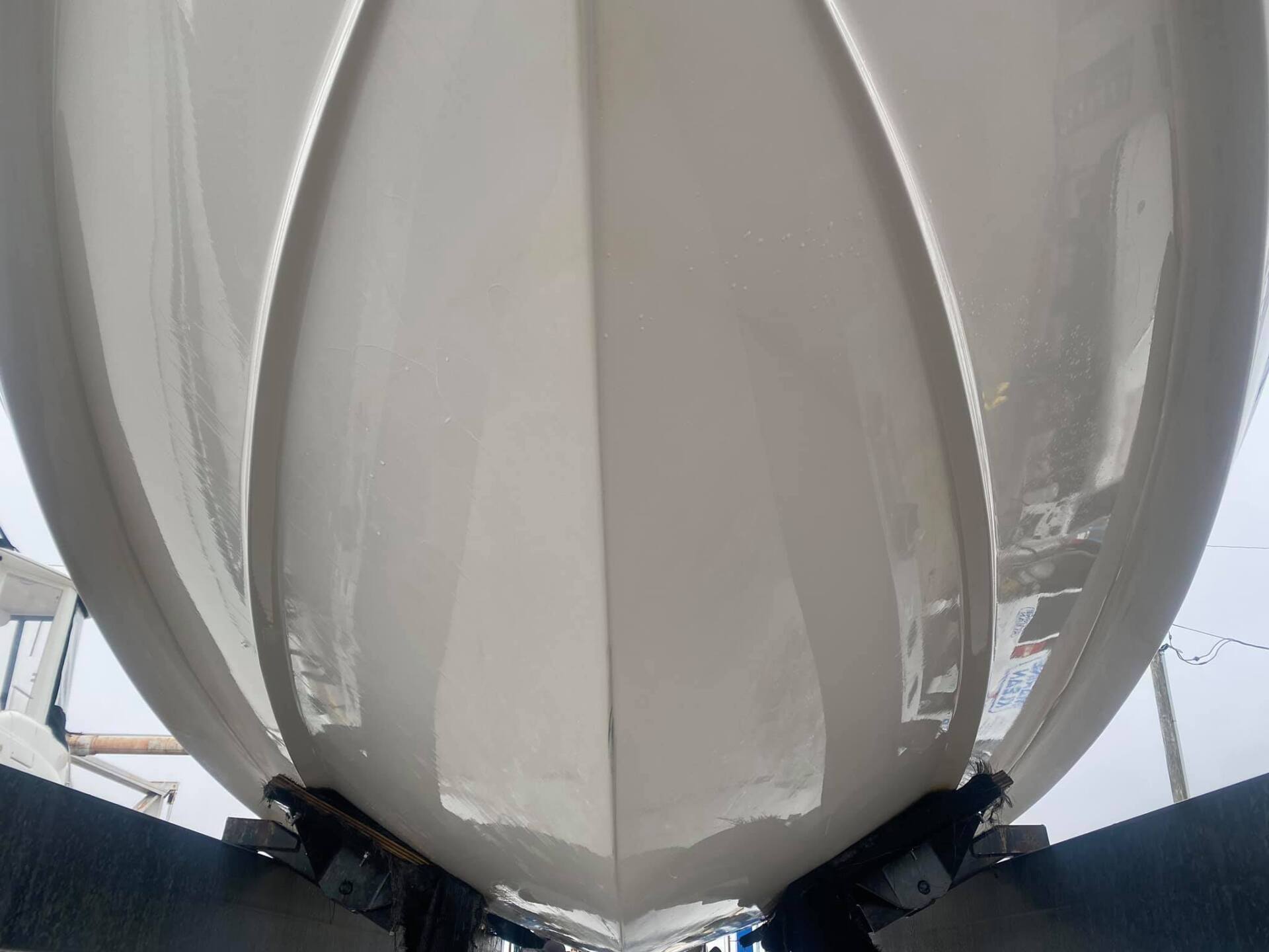 The bottom of a white boat is shown from below.