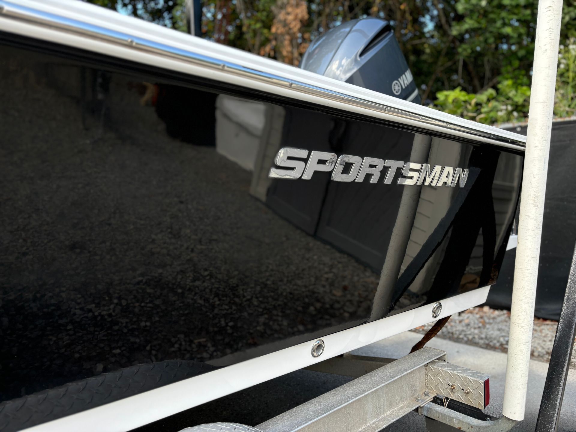 A sportsman boat is parked on a trailer