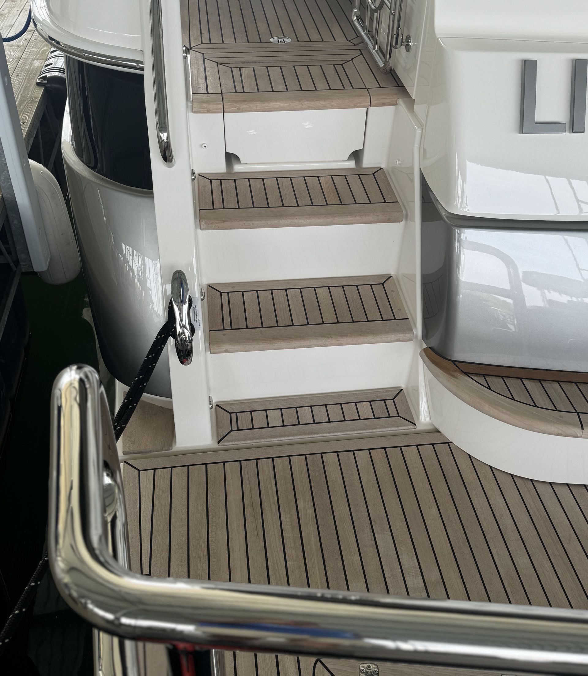 A boat with wooden stairs and a metal railing