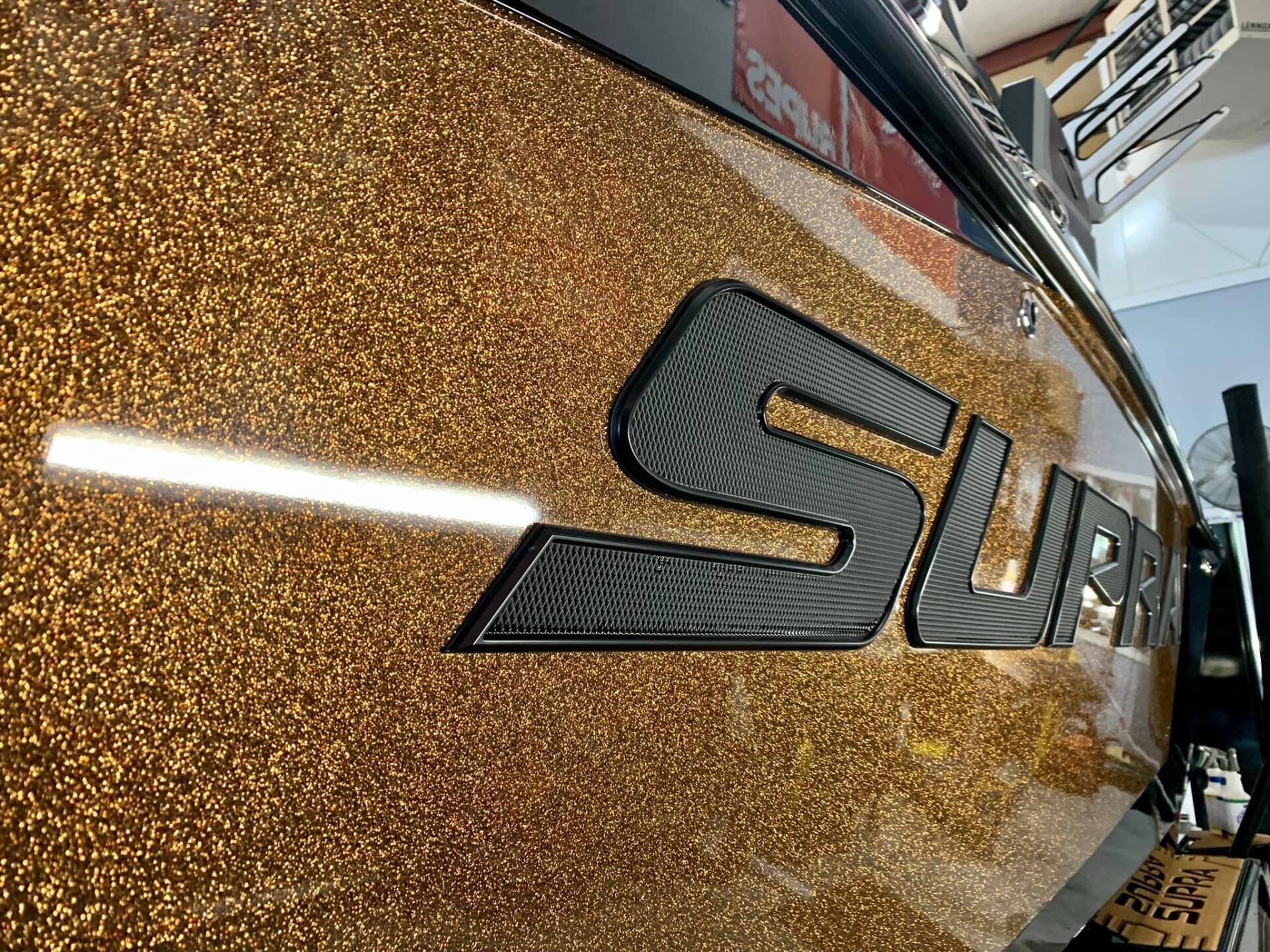 A close up of the side of a boat with the letter s on it.
