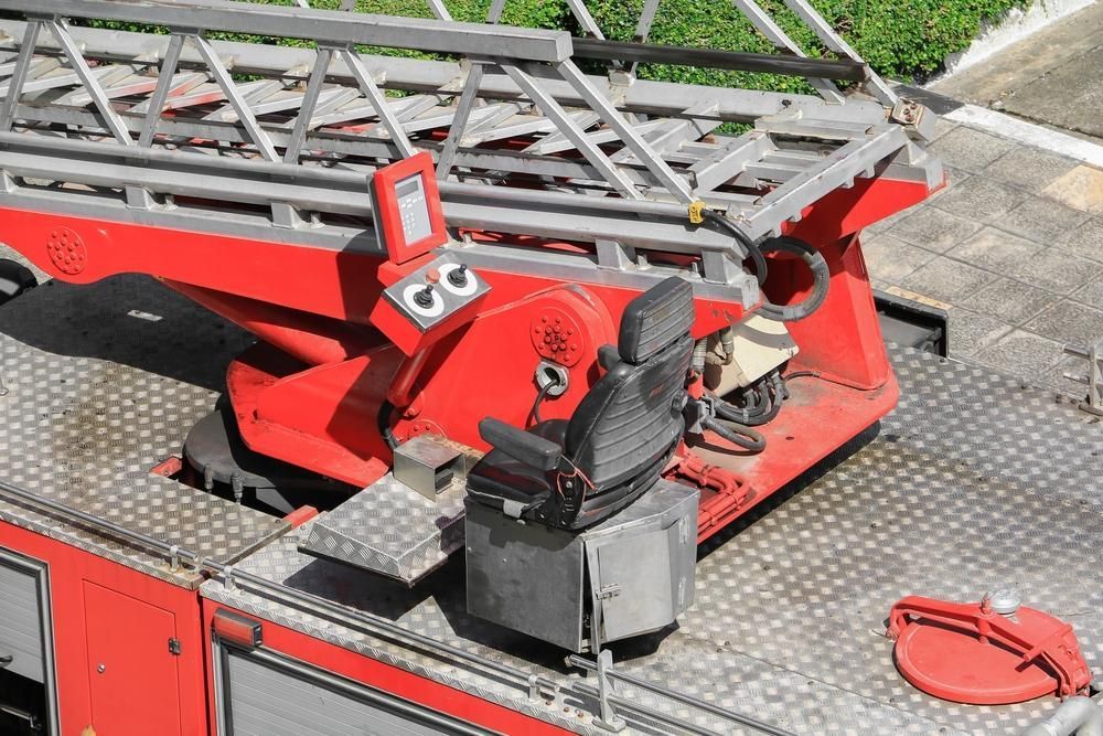 A Red Fire Truck With A Black Seat And Ladder — New England & North West Concrete Pumping In Uralla, NSW